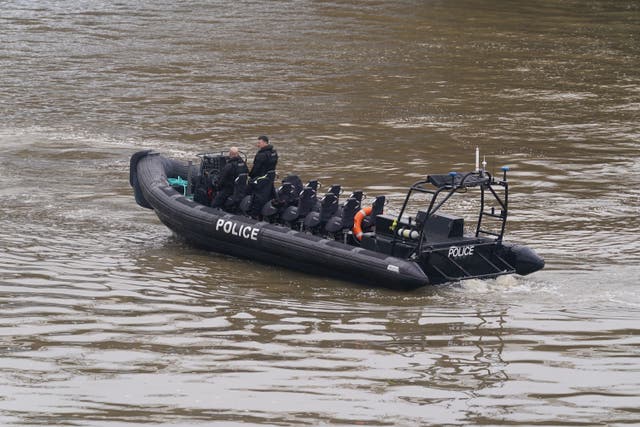 Members of the Metropolitan Police Marine Policing Unit pass near to Chelsea Bridge where they are due to search in relation to alkali attack suspect Abdul Ezedi (Lucy North/PA)