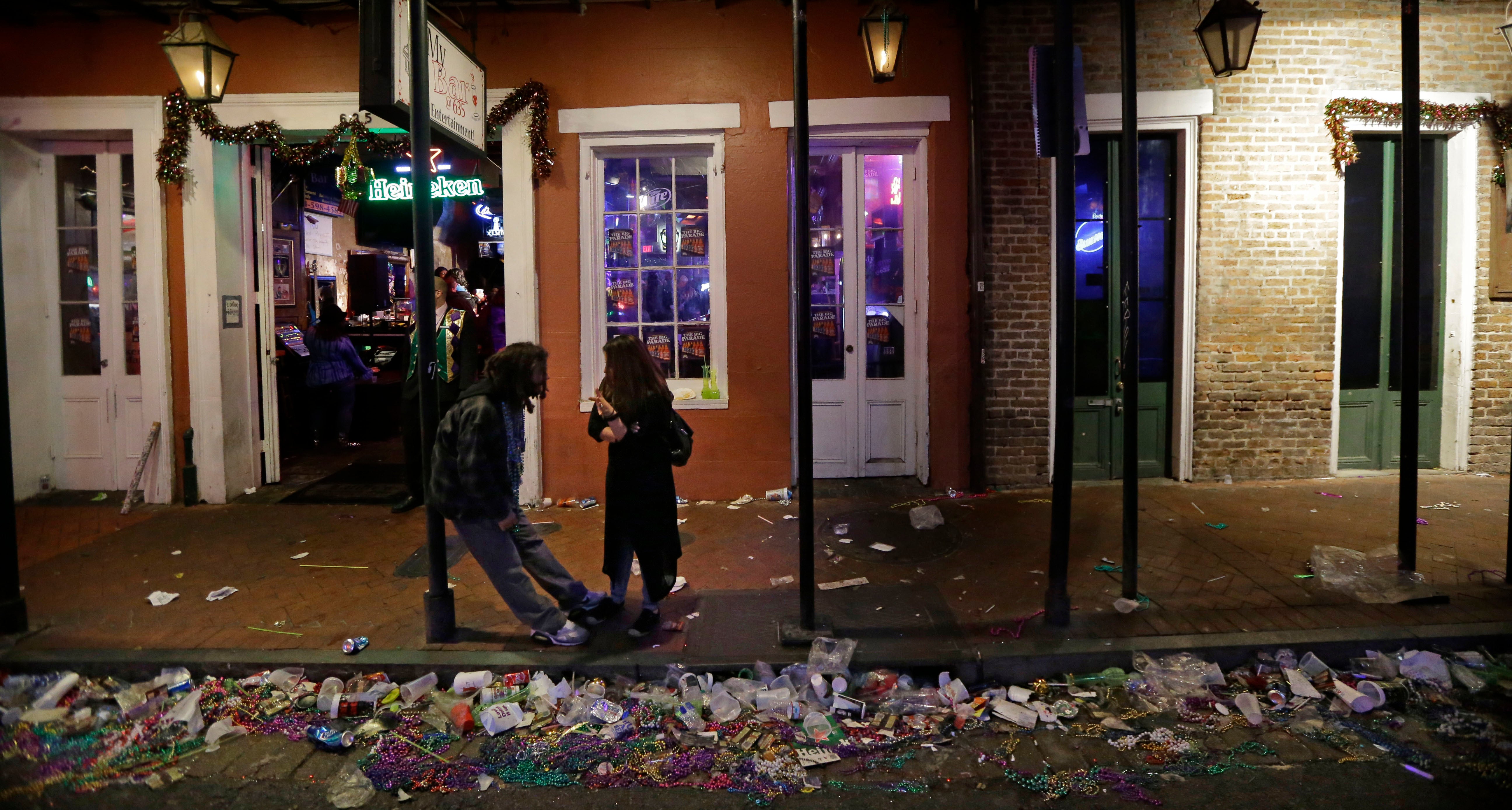 Trash lines the gutter on Bourbon Street, in the early hours of the morning after Mardi Gras, in New Orleans, Feb. 18, 2015