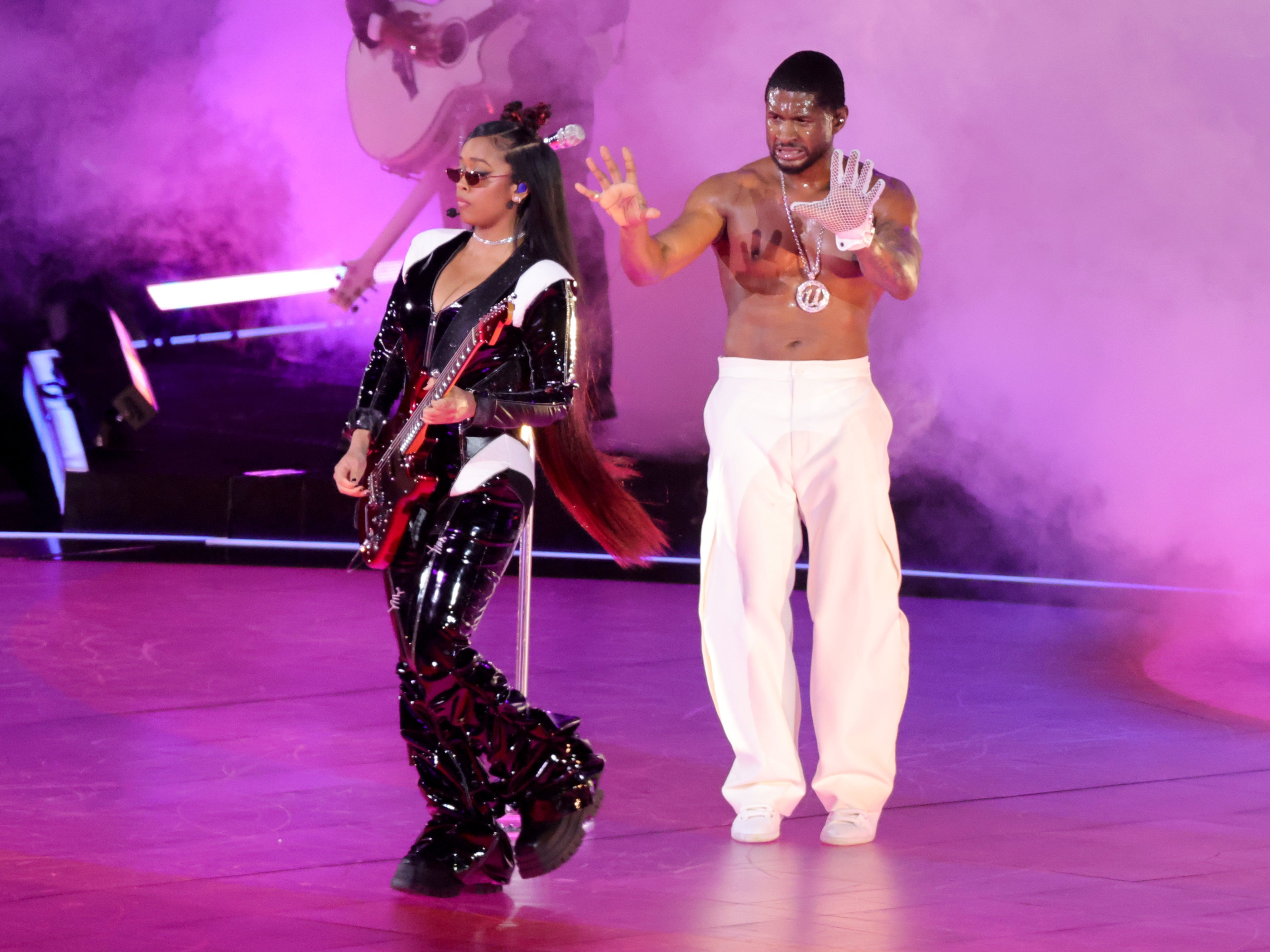 Usher performs with HER during the Super Bowl halftime show