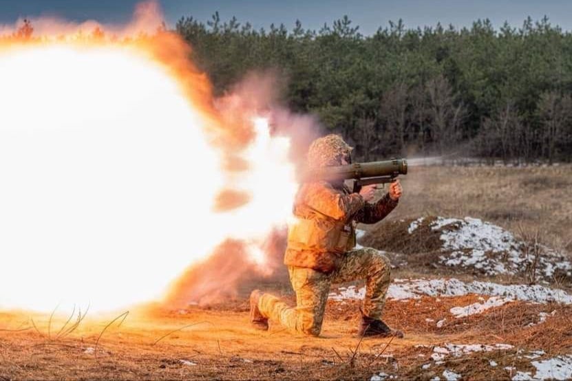 A Ukrainian soldier fires a shoulder-mounted rocket launcher at Russian positions near the frontline