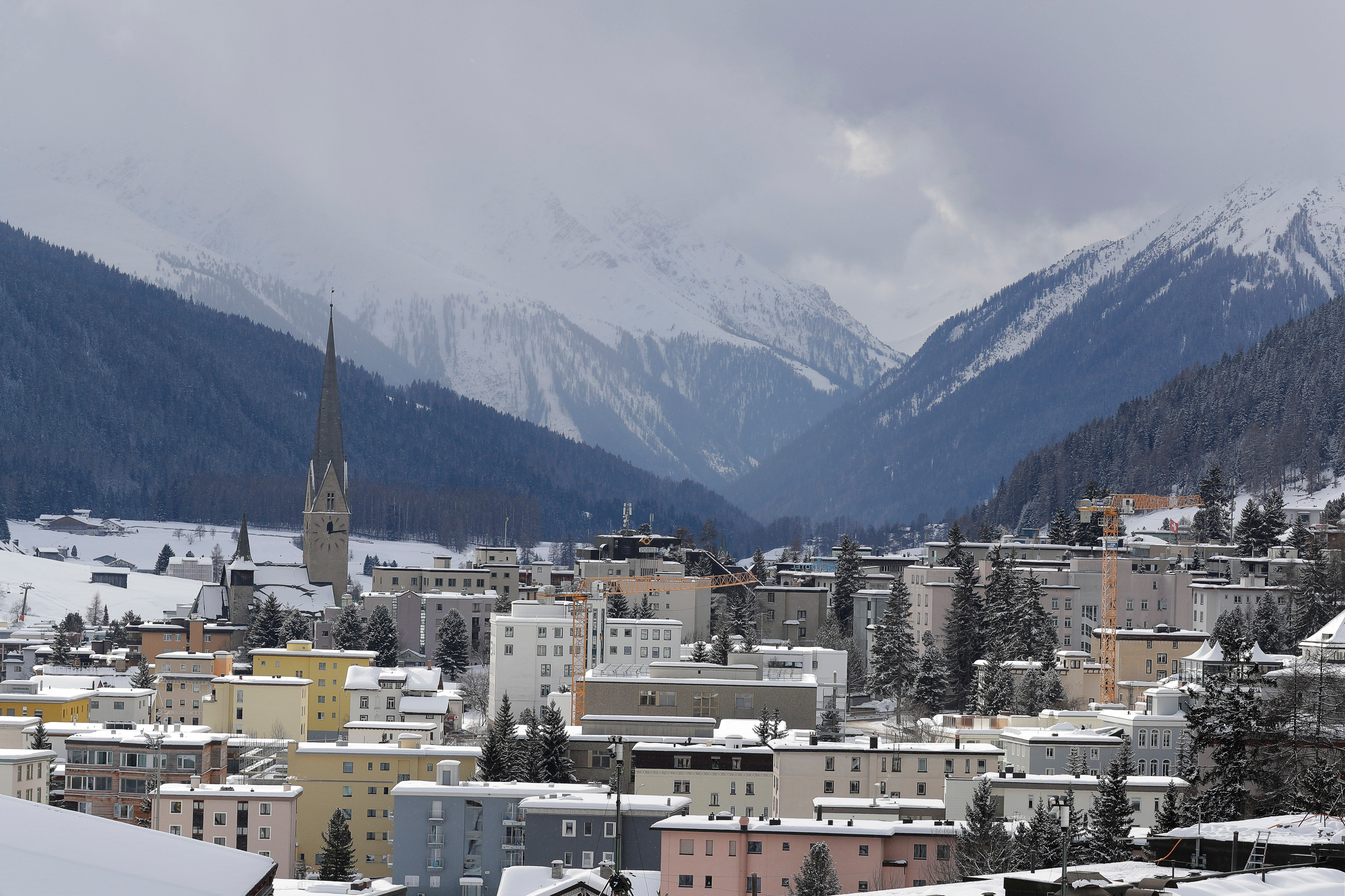 FILE -Snow covers the hills around Davos, Switzerland