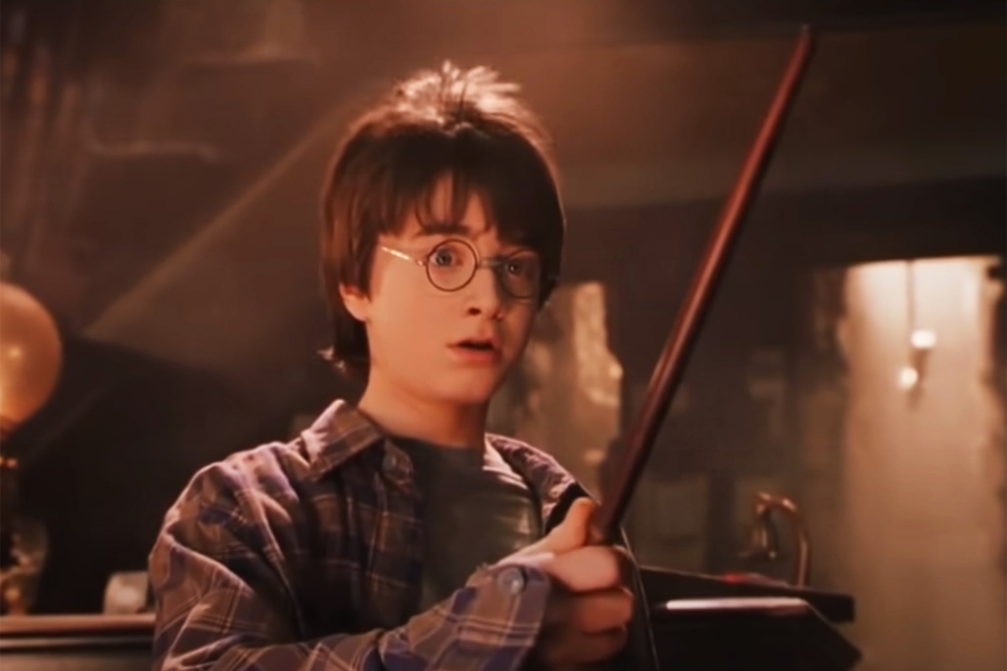 <p>Daniel Radcliffe as Harry Potter with wand in hand </p>