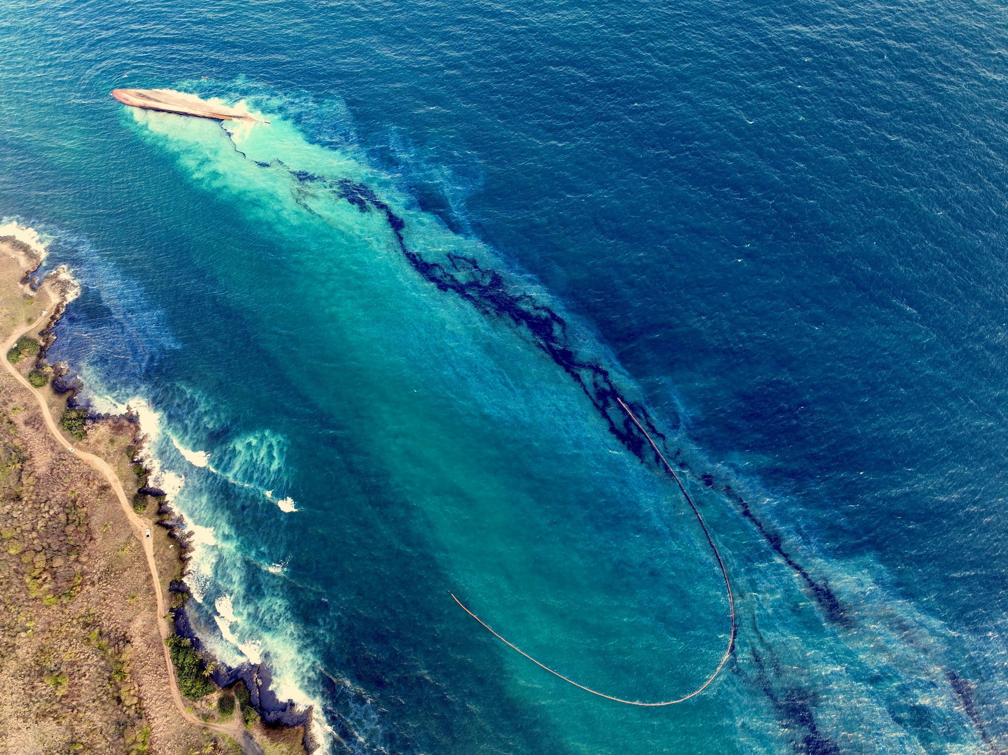 <p>An oil spill in Tobago Island, Trinidad and Tobago, leaves black residue on beach </p>