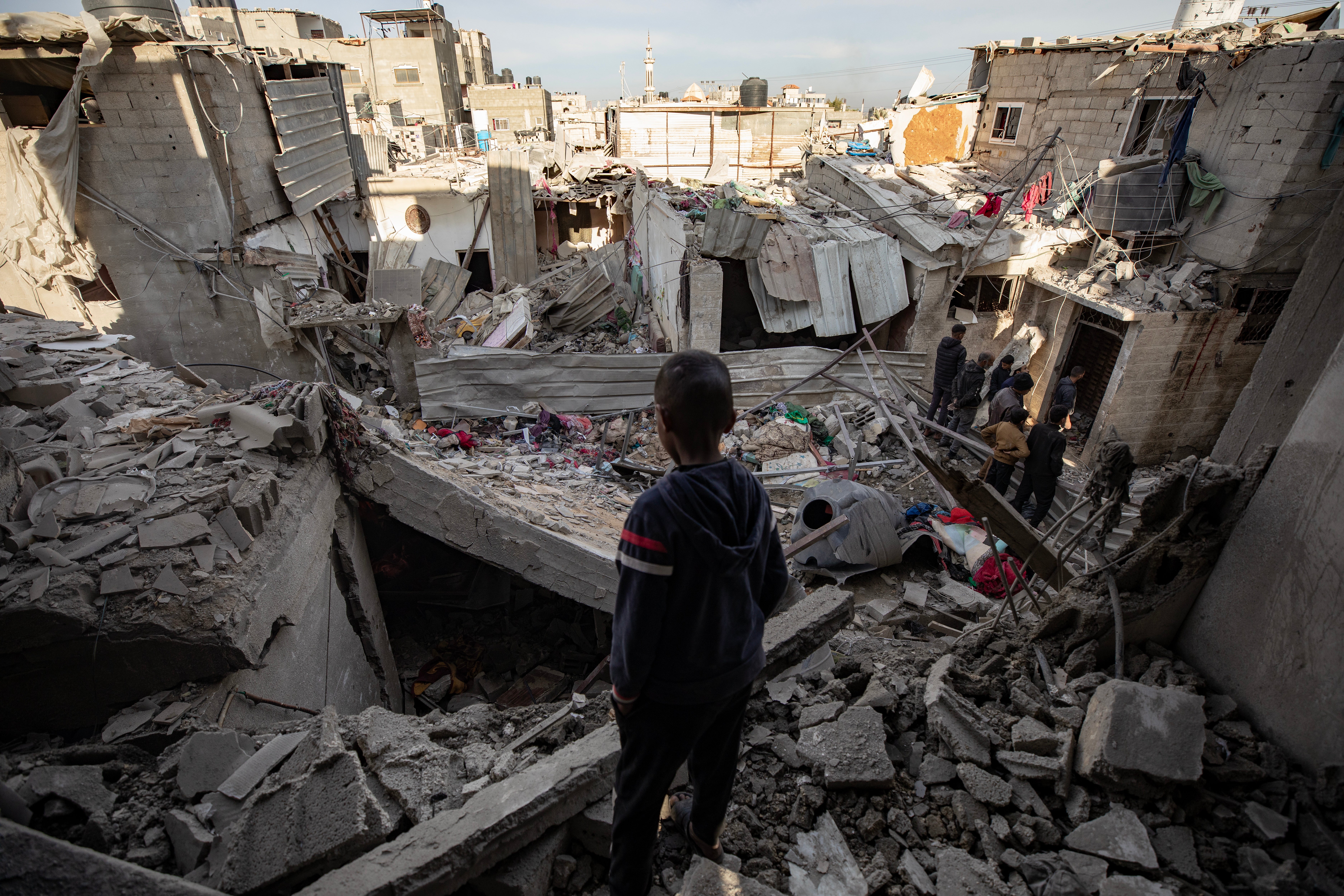 A child looks at rubble after Israeli airstrikes targeted Rafah, Gaza, overnight