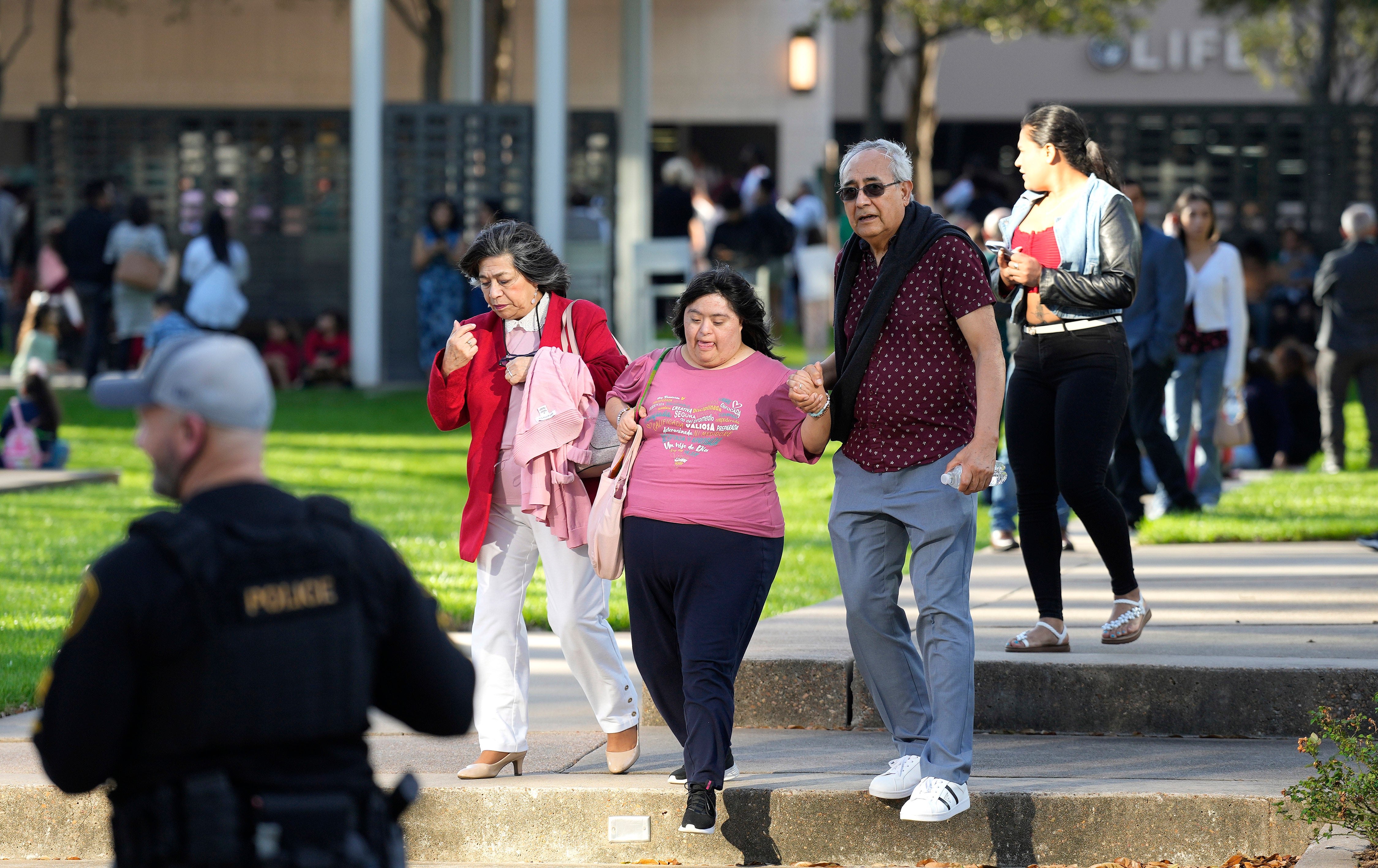 Worshippers leave the Lakewood Church on Sunday after the shooting