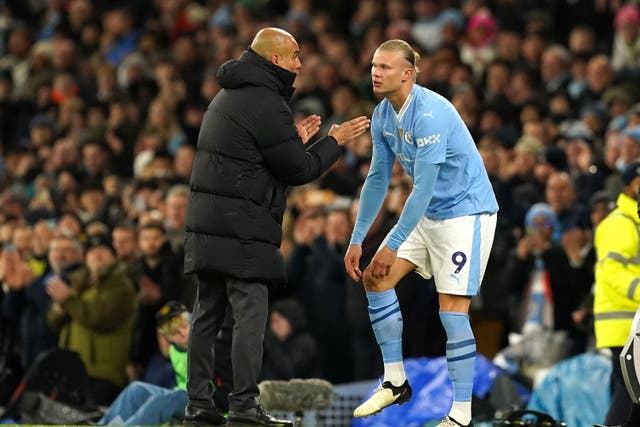 <p>Manchester City manager Pep Guardiola speaks with Erling Haaland (Martin Rickett/PA)</p>