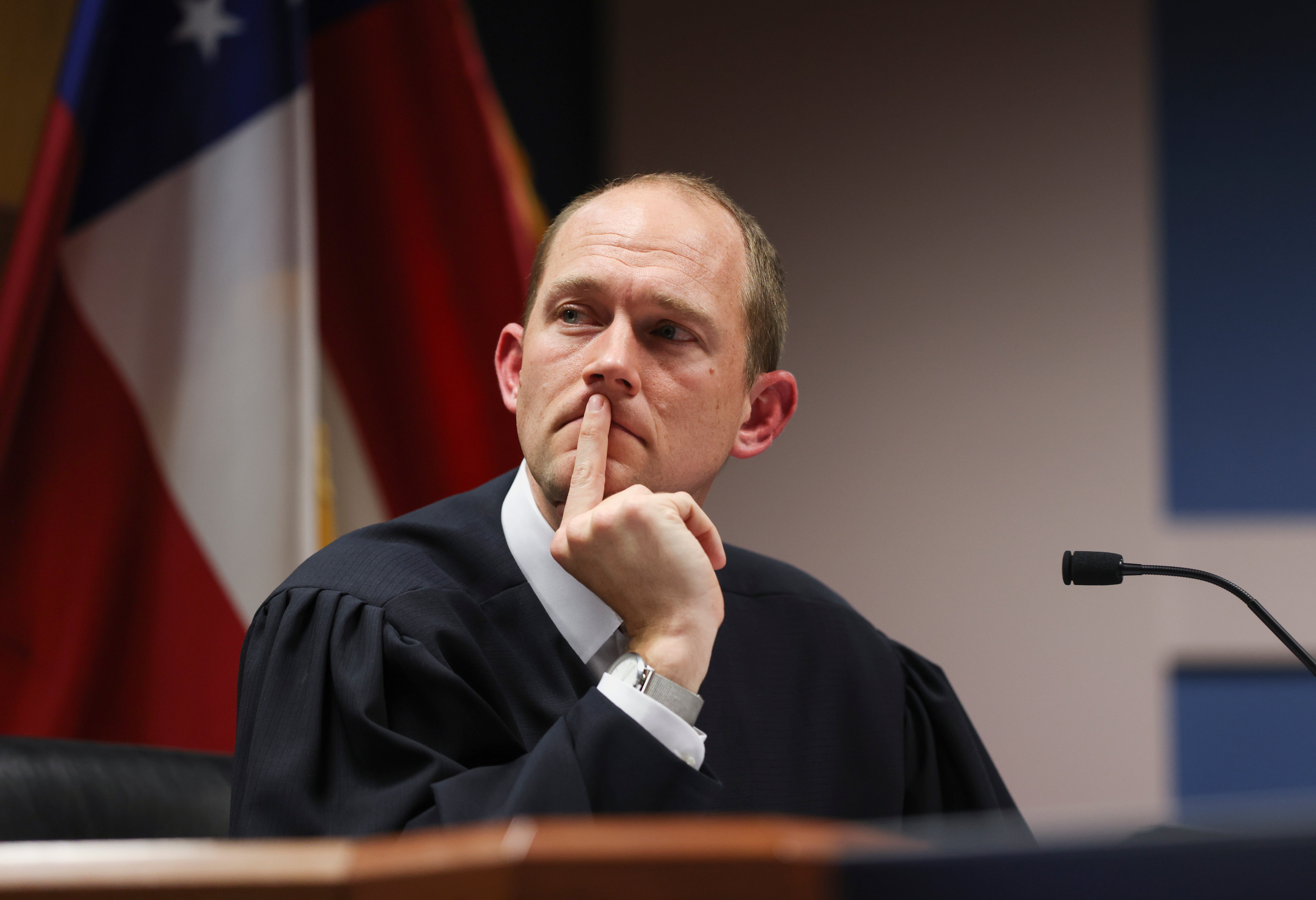 Fulton County Superior Court Judge Scott McAfee hears from attorneys in a sprawling election interference case on 12 February.