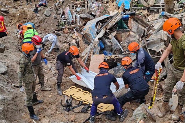 <p>In this 9 February 2024 handout photo from Municipality of Monkayo, rescuers recover bodies at the landslide-hit village of Maco in Davao de Oro province, southern Philippines</p>