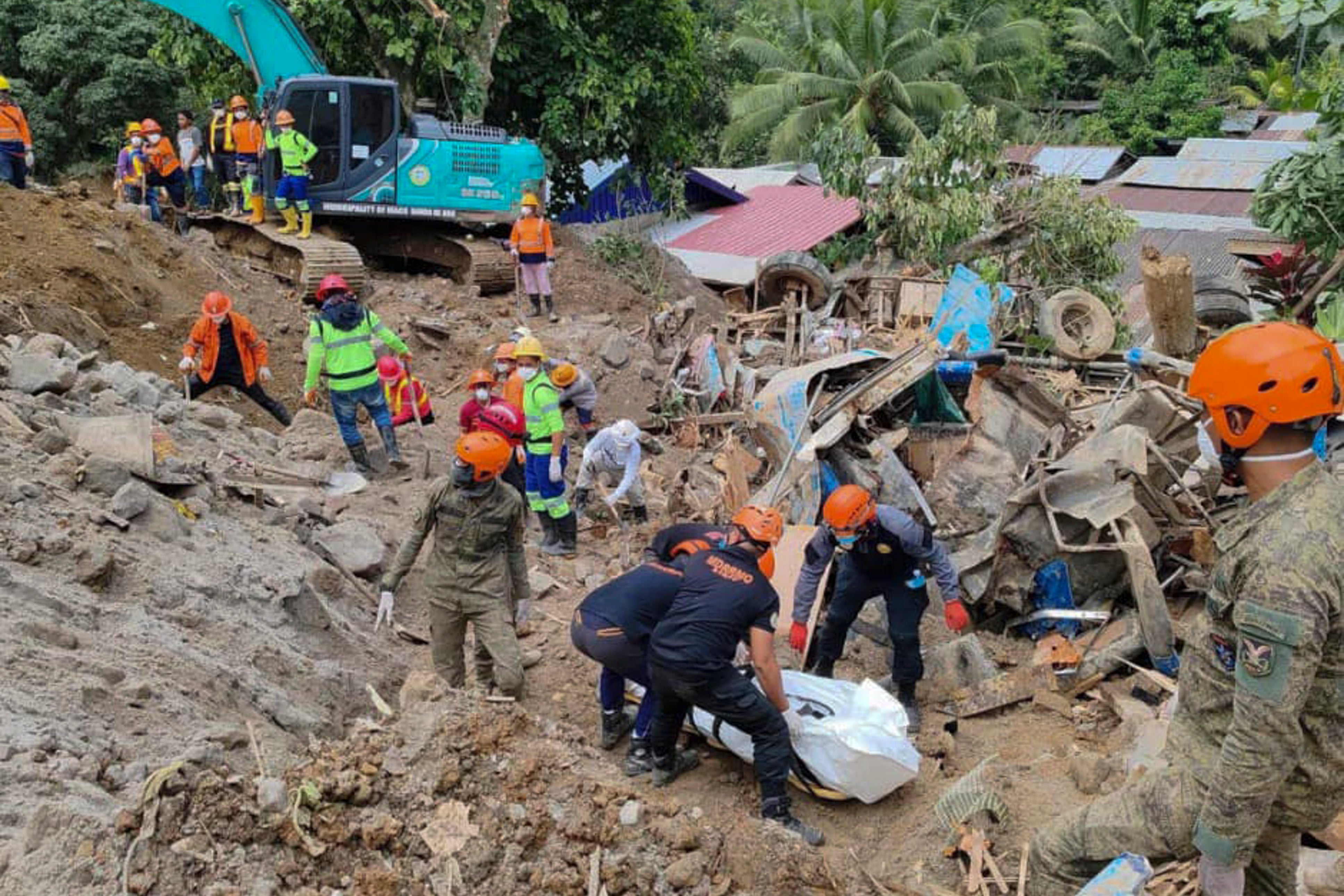 In this 9 Feburary 2024 handout photo from Municipality of Monkayo, rescuers recover bodies at the landslide-hit village of Maco in Davao de Oro province, southern Philippines