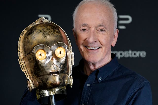 Actor Anthony Daniels looks at the head from his C-3PO costume (Andrew Matthews/PA Wire