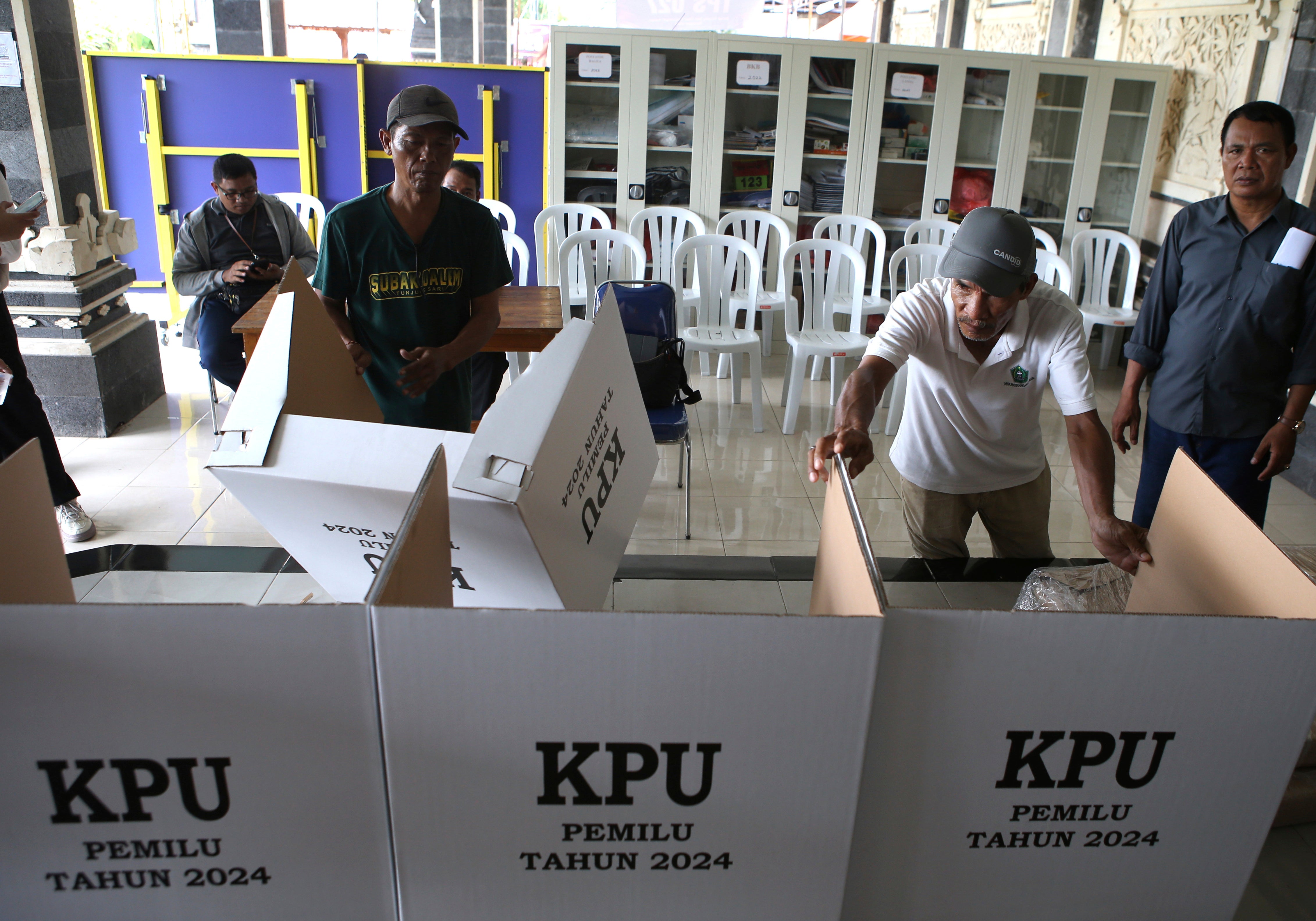 Men prepare a polling station in Denpasar, Bali, Indonesia