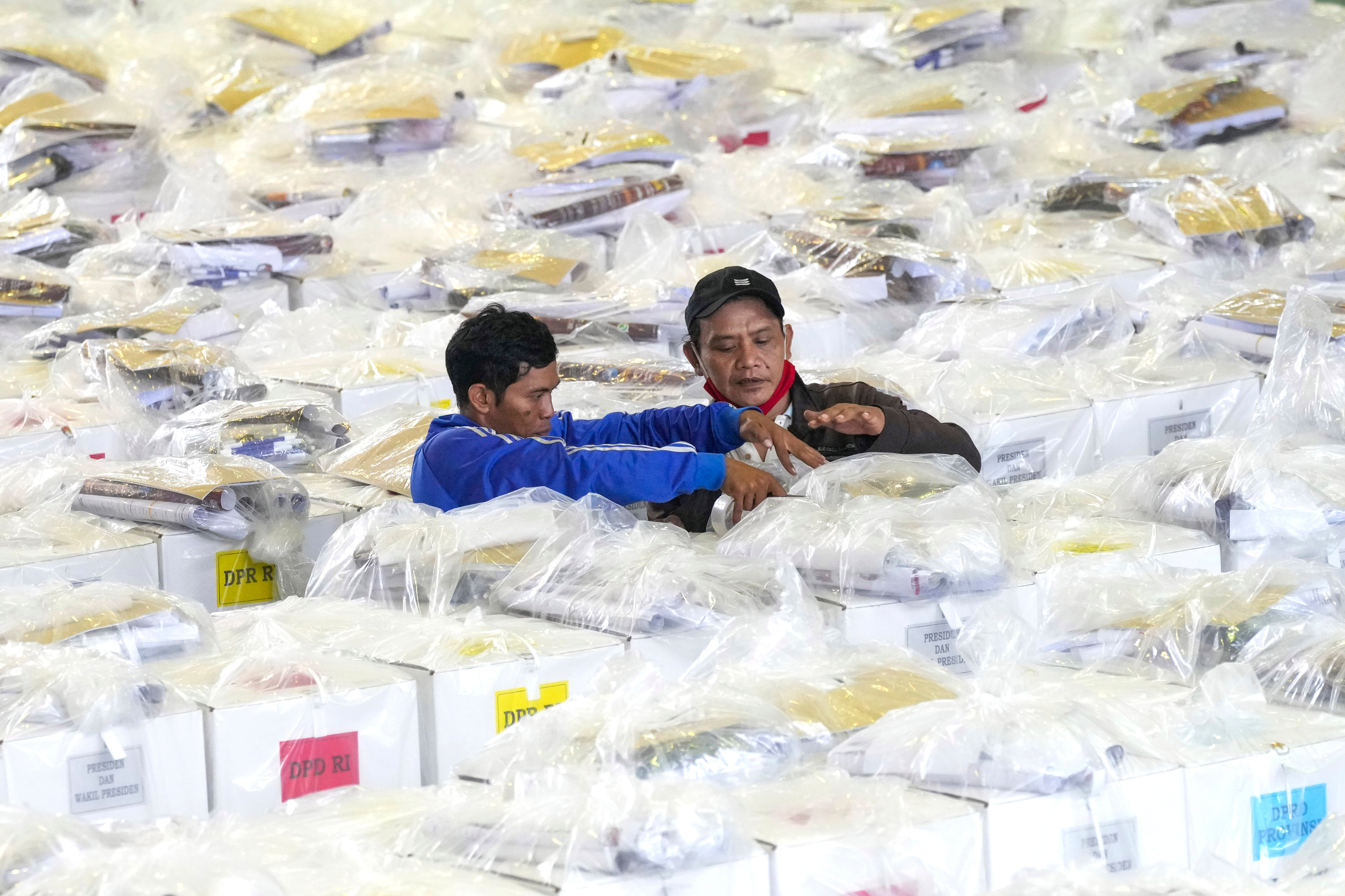 Workers prepare ballot boxes to be distributed to polling stations ahead of elections