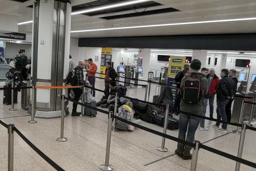 Anxious passengers queue at Birmingham airport at 11pm