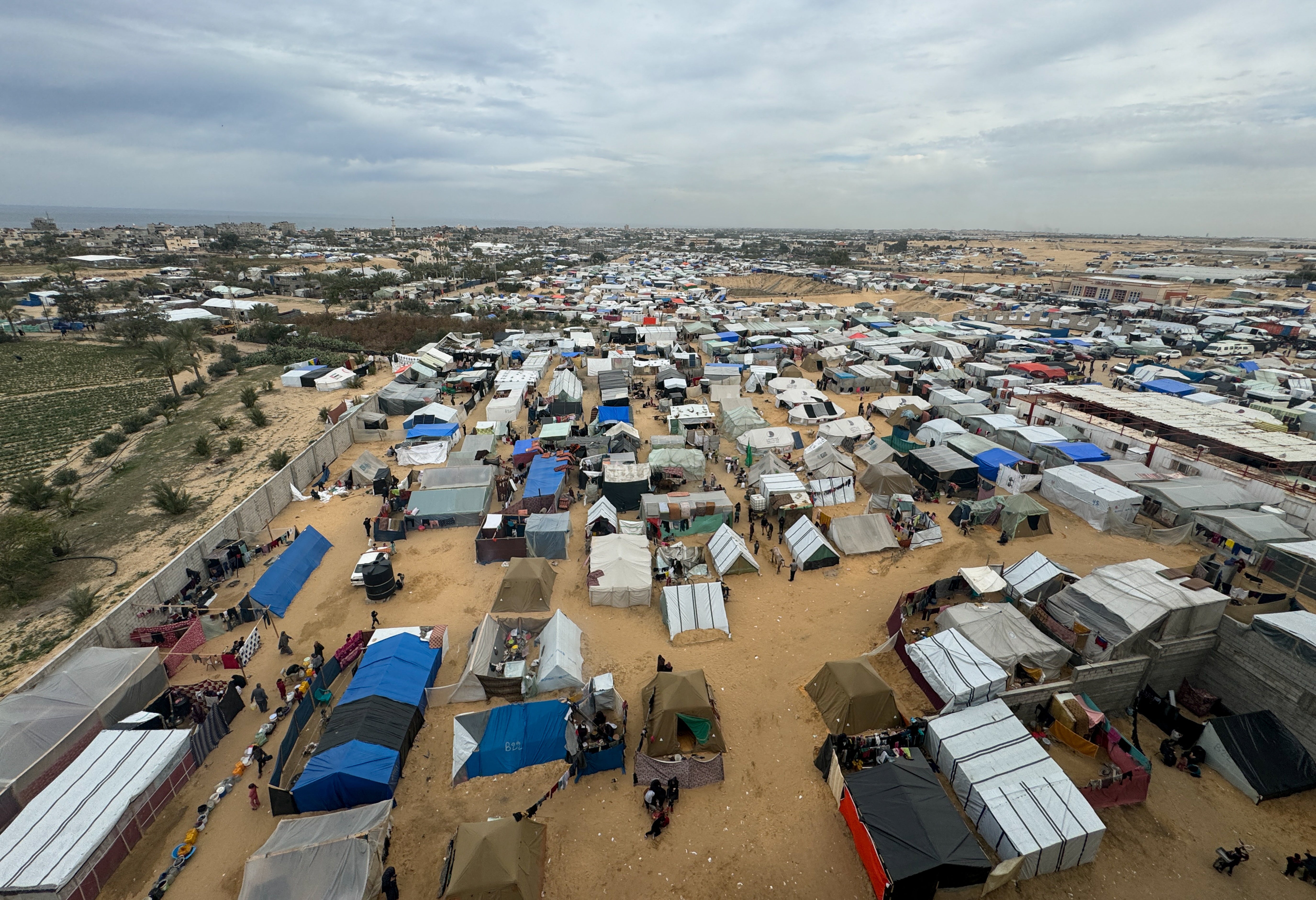 Displaced Palestinians who fled their houses due to Israeli strikes take shelter in a tent camp, in Rafah