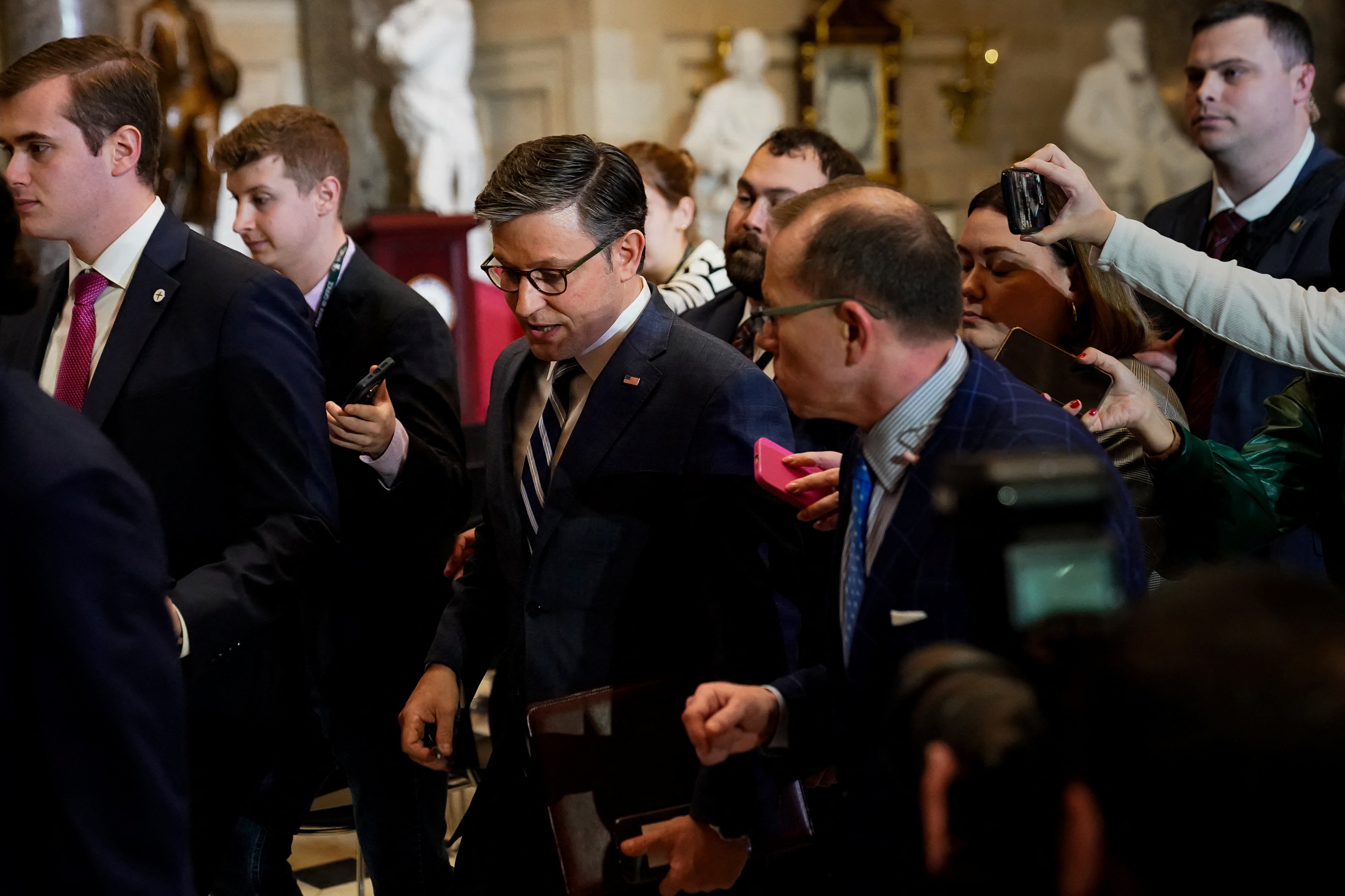 Mike Johnson, centre, has been all but ordered by Donald Trump to prevent Biden scoring a foreign policy victory over Ukraine