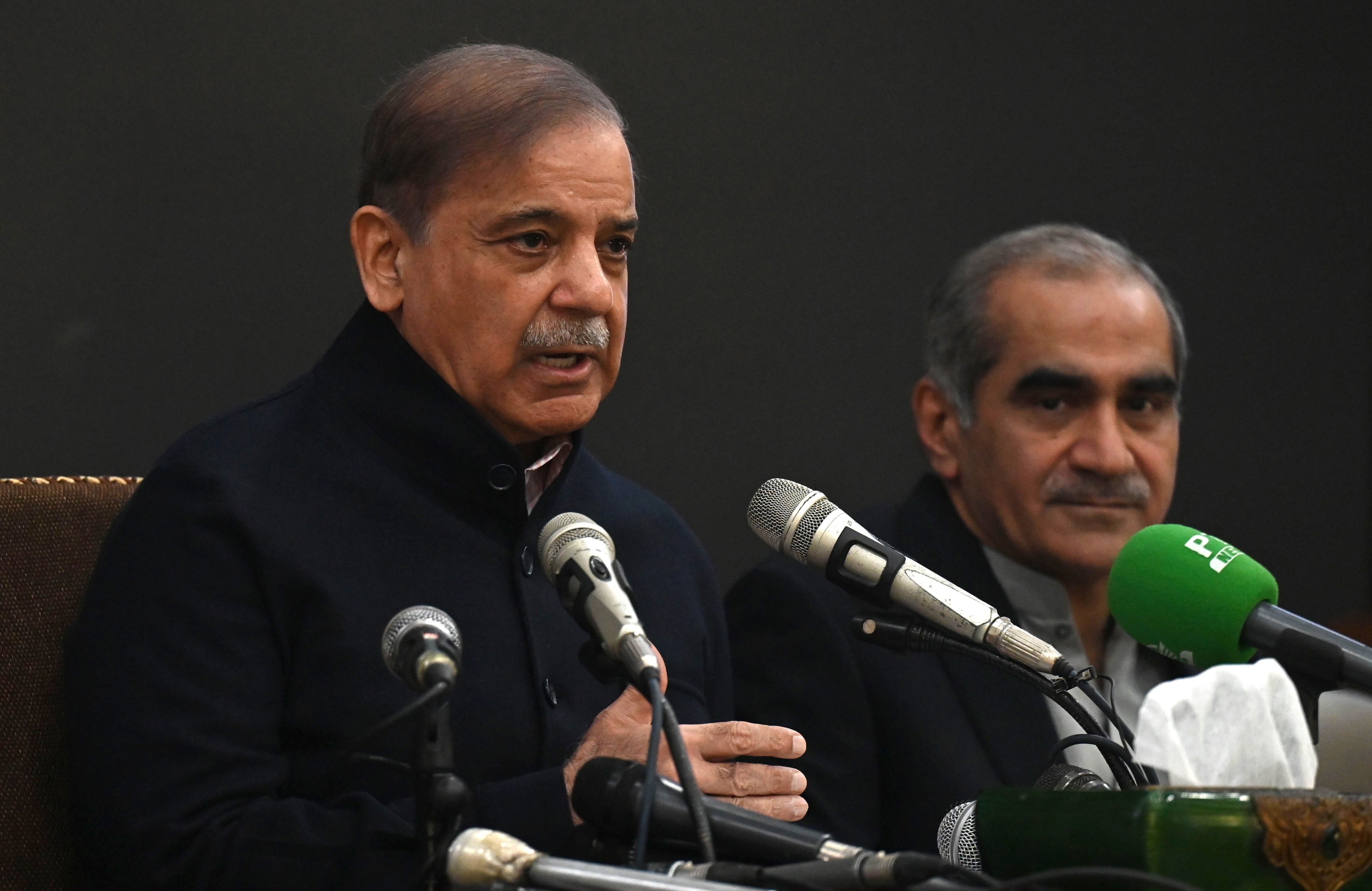 Pakistan's former prime minister and leader of the Pakistan Muslim League-Nawaz (PML-N) party Shehbaz Sharif (L) speaks during a press conference in Lahore, Pakistan, 13 Febuary 2024