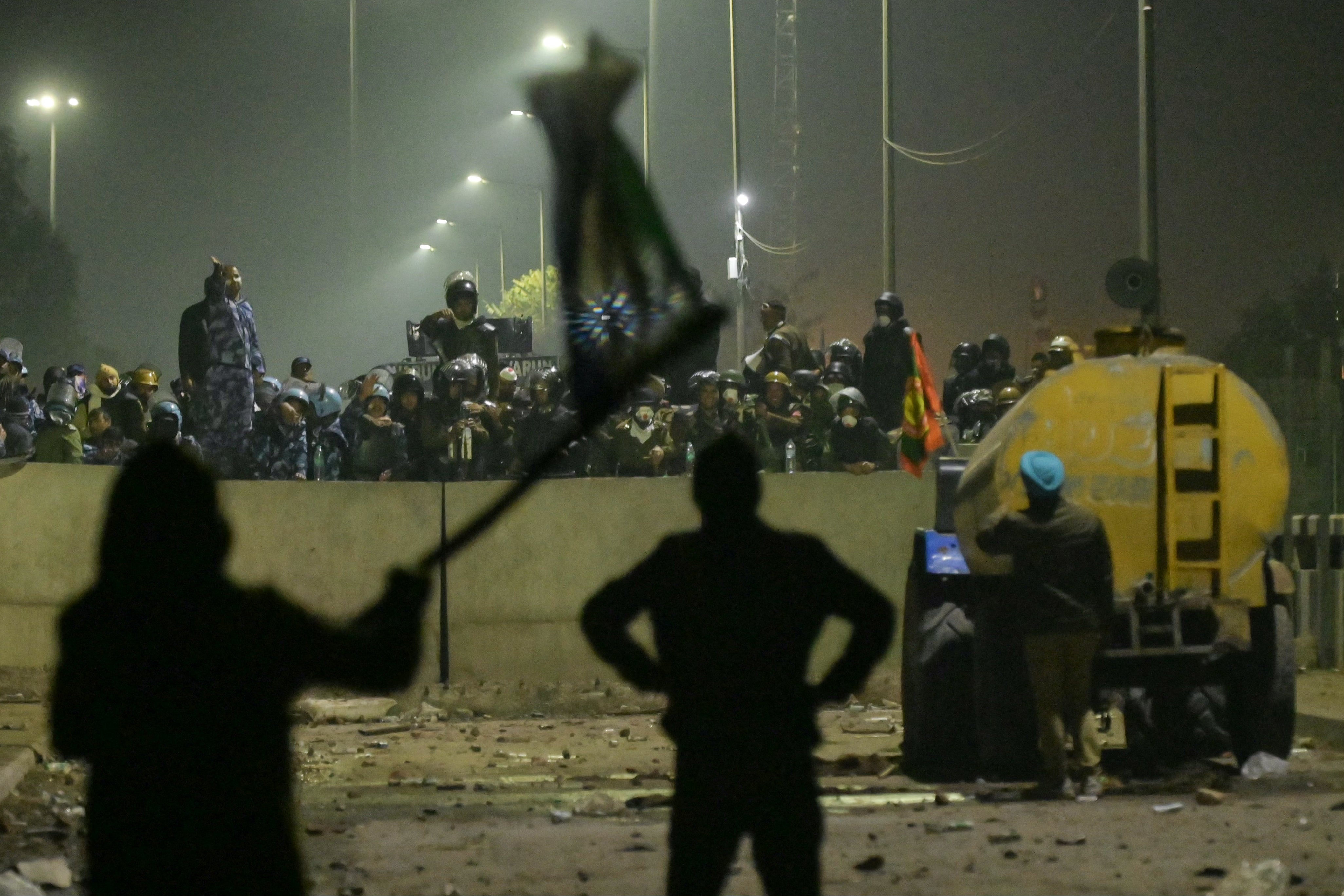 Paramilitary forces block a highway to prevent farmers from marching towards India’s capital during a protest demanding minimum crop prices, at Shambhu Haryana-Punjab border near Delhi