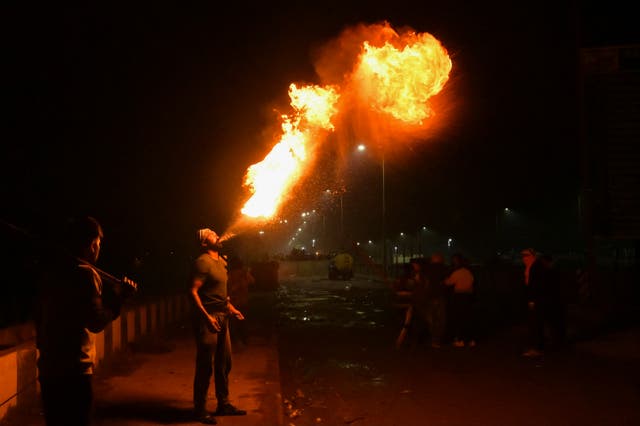 <p>A farmer performs a fire breathing act during a protest demanding minimum crop prices, at Shambhu Haryana-Punjab border near Ambala some 220 Km from New Delhi</p>