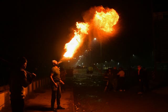 <p>A farmer performs a fire breathing act during a protest demanding minimum crop prices, at Shambhu Haryana-Punjab border near Ambala some 220 Km from New Delhi</p>