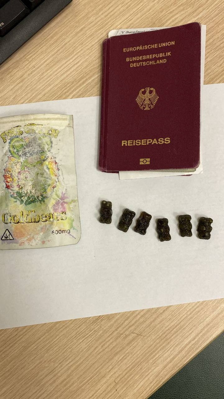 A view shows a passport and other items, what Russian customs officials called the belongings of a German citizen who was detained on arrival in the Russian city of Saint Petersburg with gummy candies containing cannabis, at an unknown location in Russia