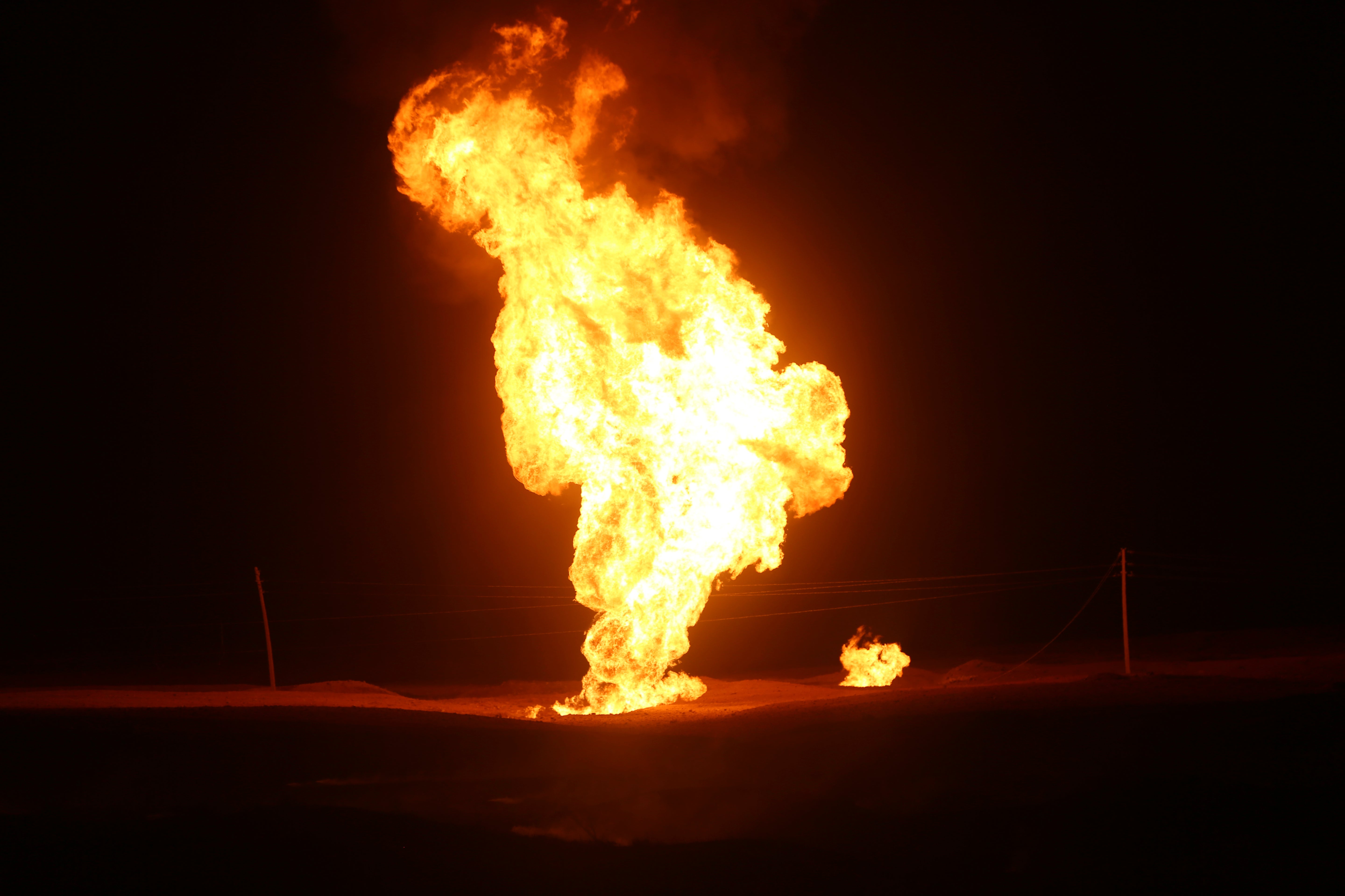Flames leap into the air after a natural gas pipeline explodes outside the city of Boroujen
