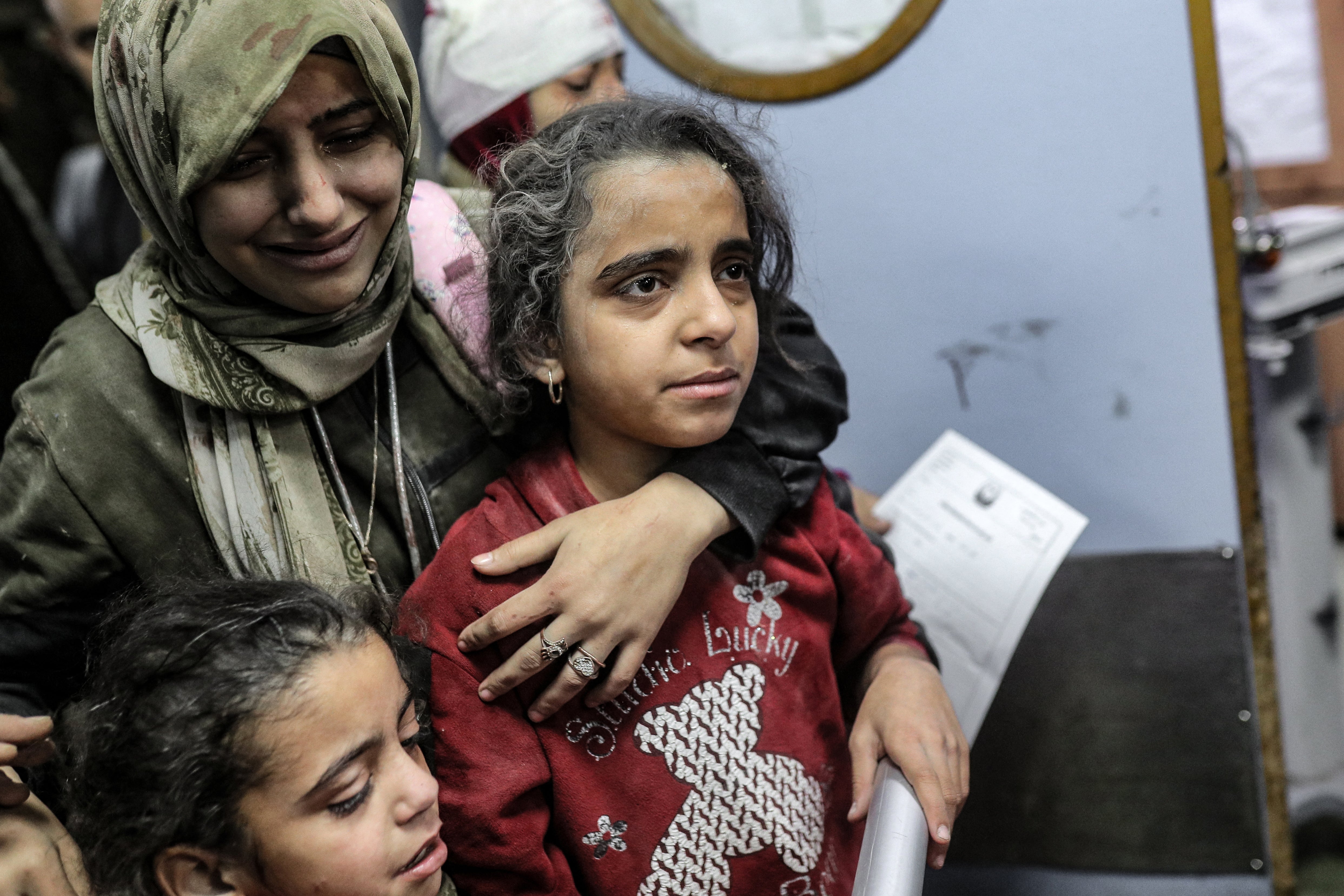 Palestinians, wounded in an Israeli strike, receive treatment at the Nasser hospital in Khan Younis