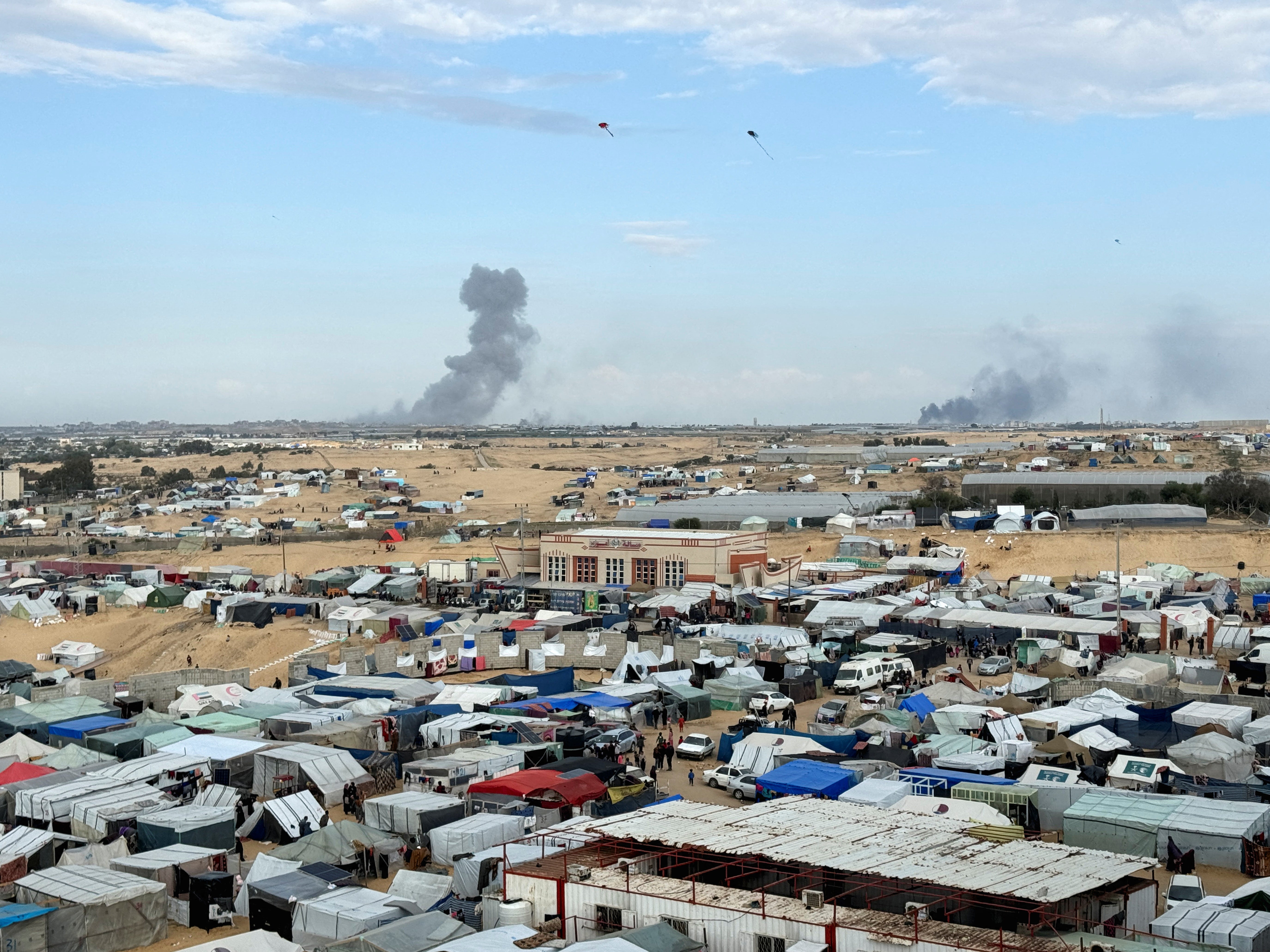 Smoke from the ground operation in Khan Younis, seen from a camp sheltering displaced Palestinians in Rafah