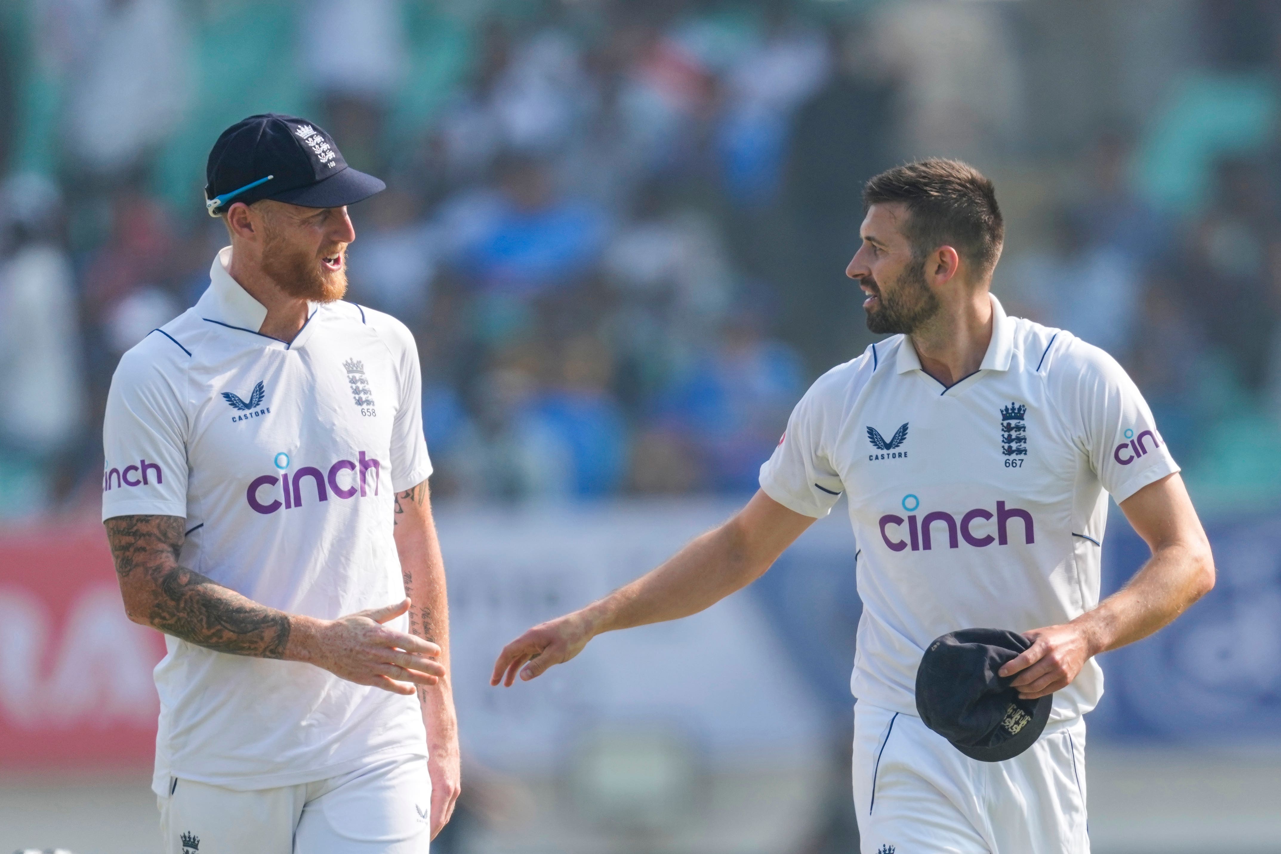 England’s captain Ben Stokes, left talks with Mark Wood on the first day of the third match in India (Ajit Solanki, AP)