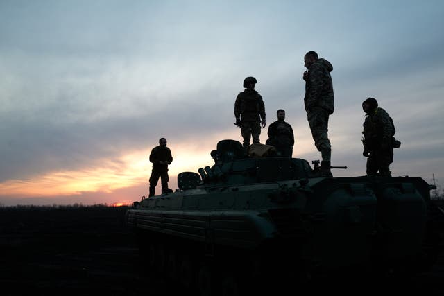 <p>Soldiers stand on the Armoured Infantry Vehicle 2 (BMP-2) on the road to the city, on the outskirts of Avdiivka</p>