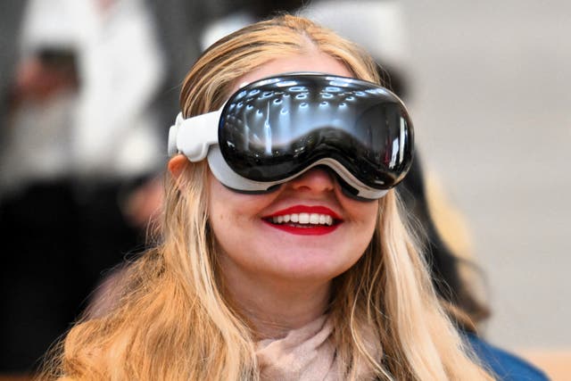 <p>A customer tries on the Apple Vision Pro headset during the product release at the Apple Store in New York City on 2 February, 2024</p>