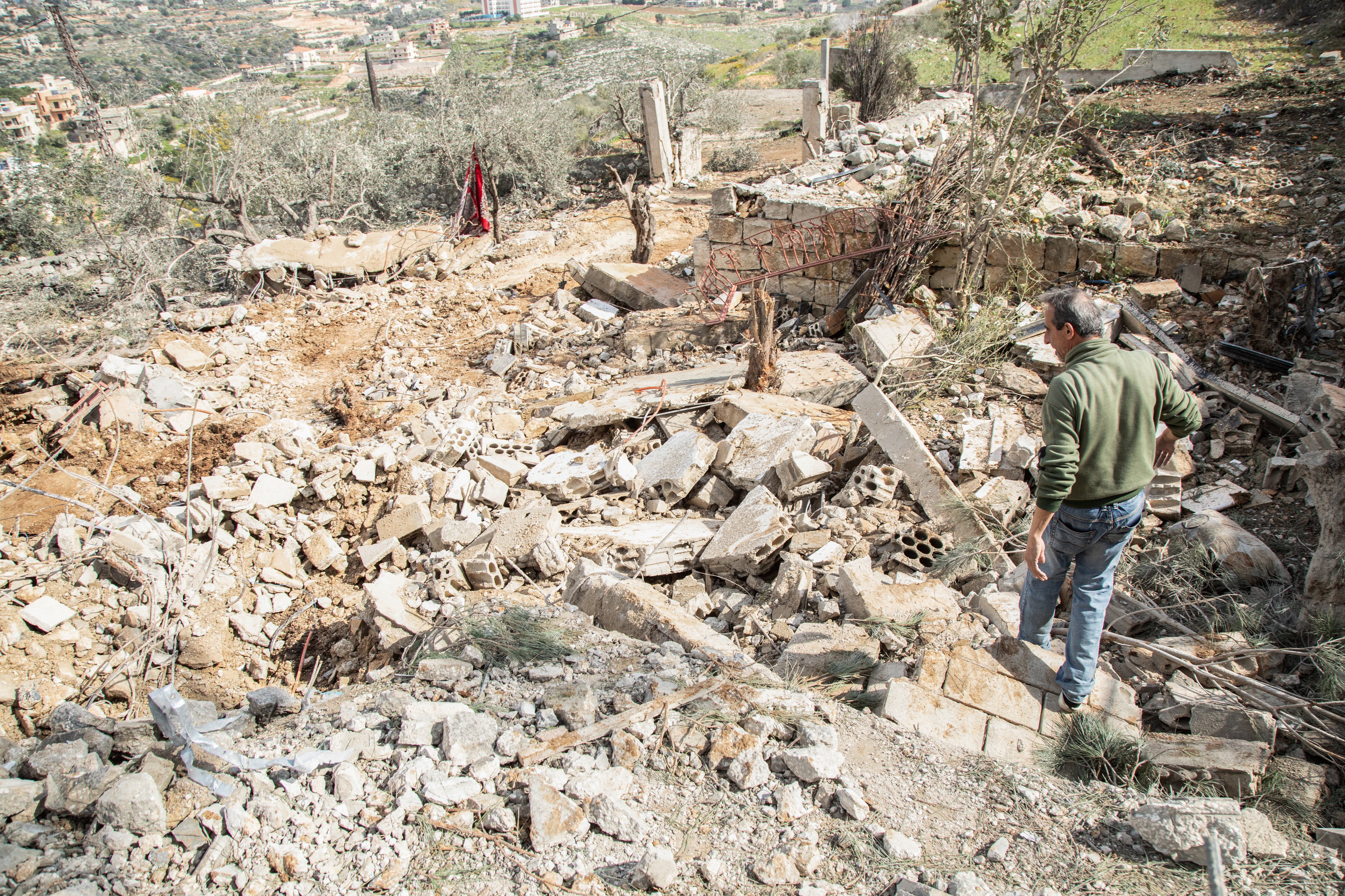 A man checks the destruction following an Israeli airstrike the previous day on the village of Taybeh near the border with Israel in southern Lebanon, on 15 February 2024