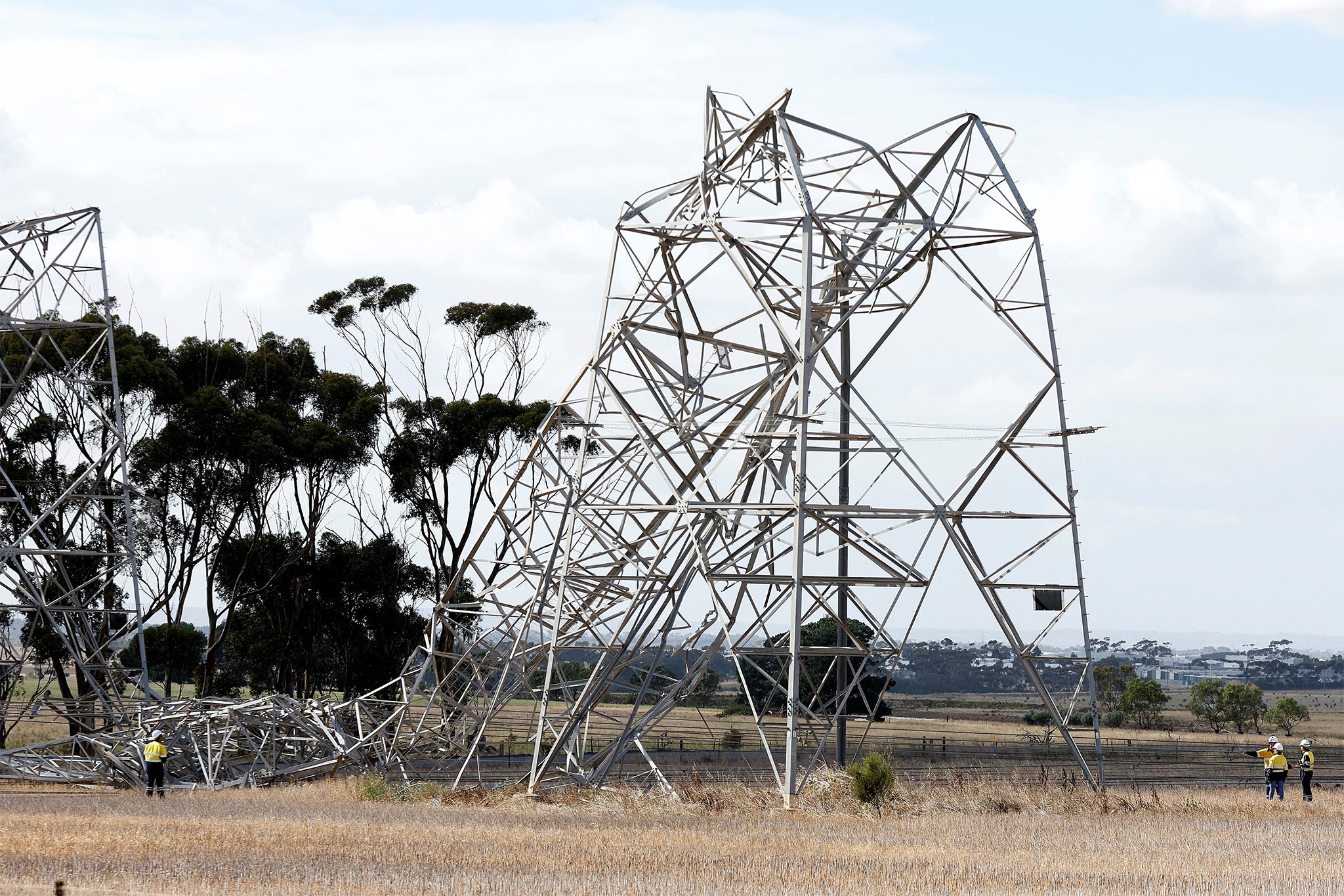 Workers inspect damaged transmission towers at Anakie in Victoria, Australia