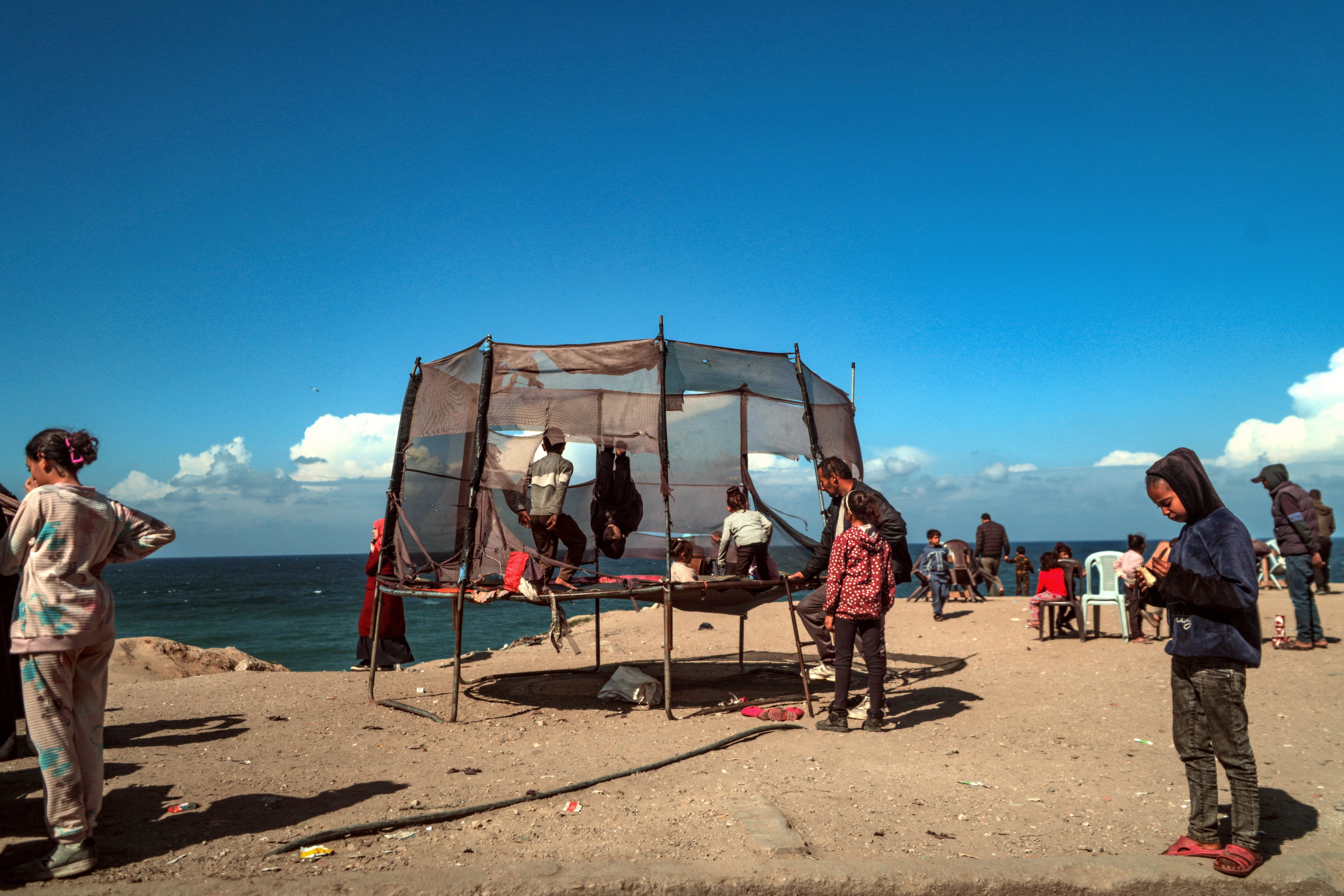 Palestinian children displaced with their families from Rafah play next the beach in Deir Al Balah, southern Gaza Strip, 14 February 2024