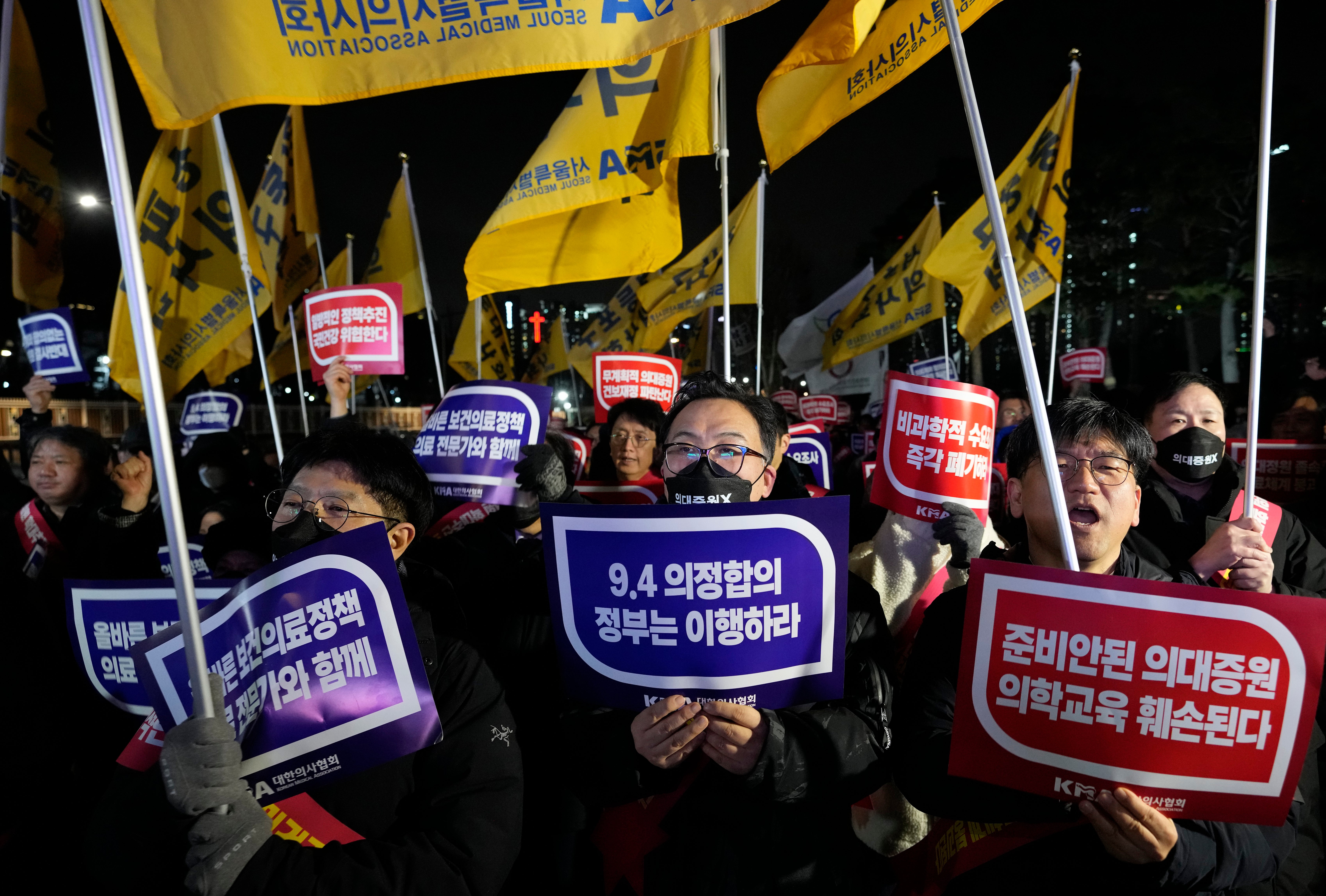 Doctors stage a rally against the government’s medical policy near the presidential office in Seoul, South Korea