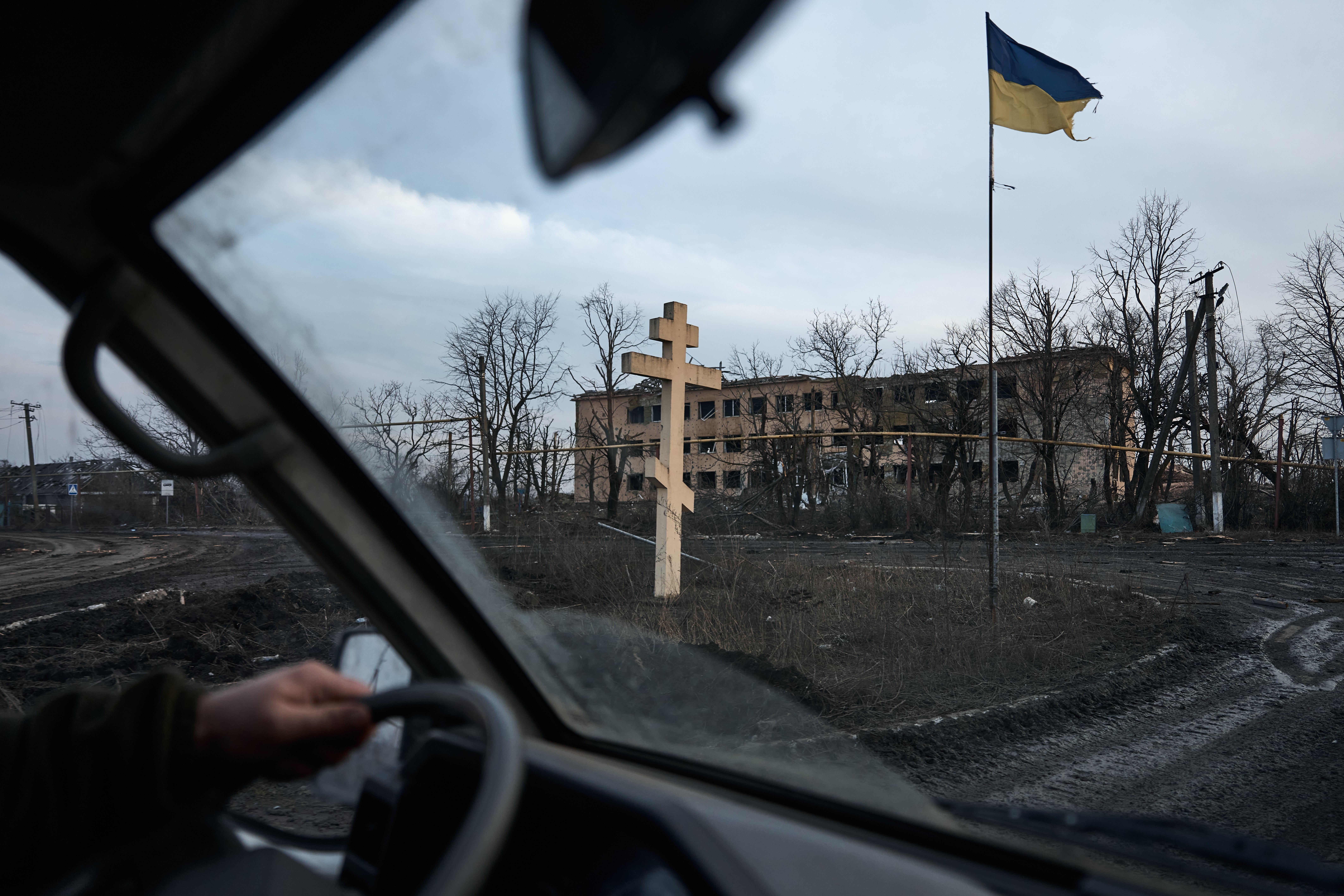 A Ukrainian flag flies on the road to the city, the outskirts of Avdiivka on 14 February, 2024. Ukrainian forces began withdrawing only three days later