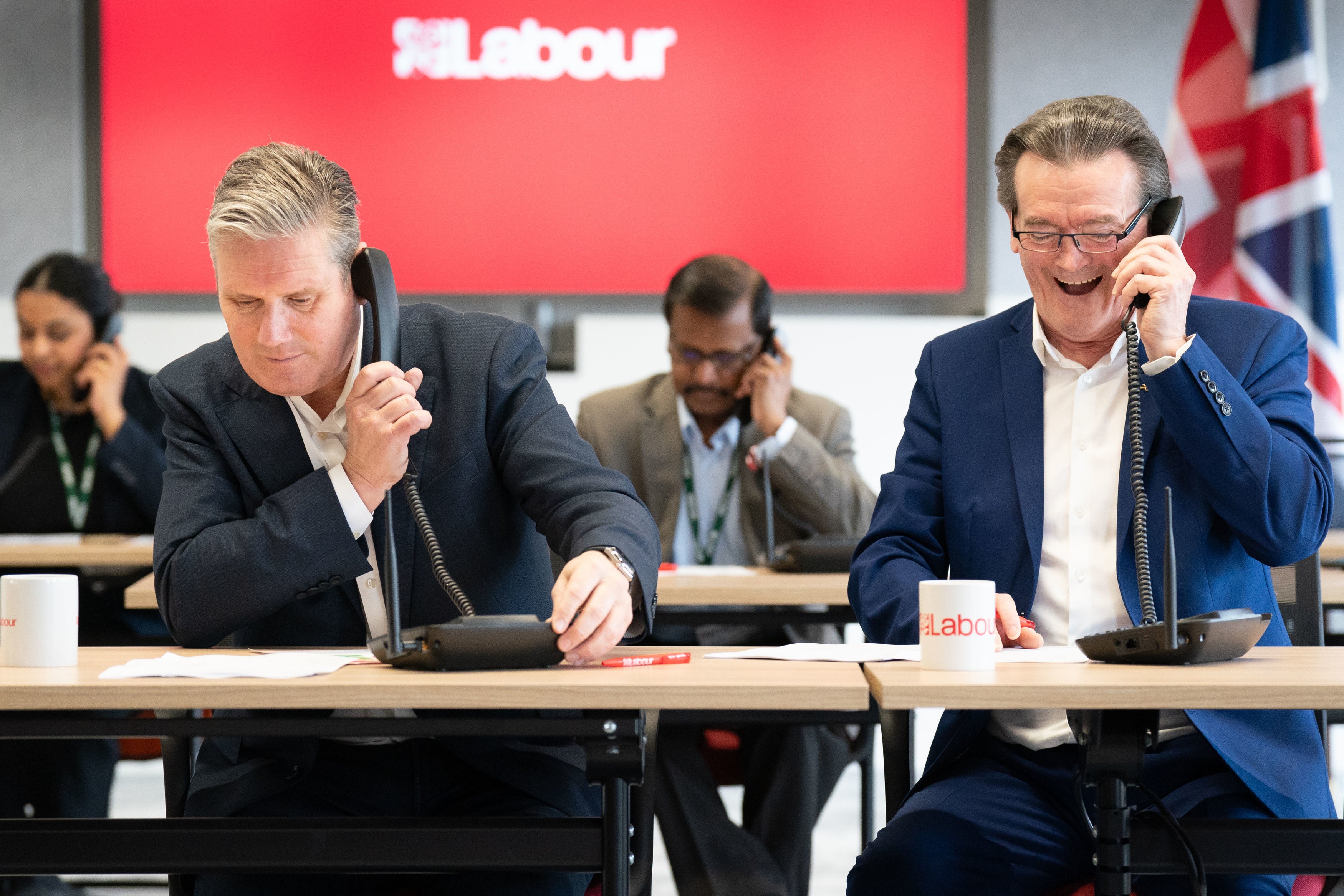 Labour leader Sir Keir Starmer (left) is joined by musician Feargal Sharkey canvassing voters by phone for the Wellingborough