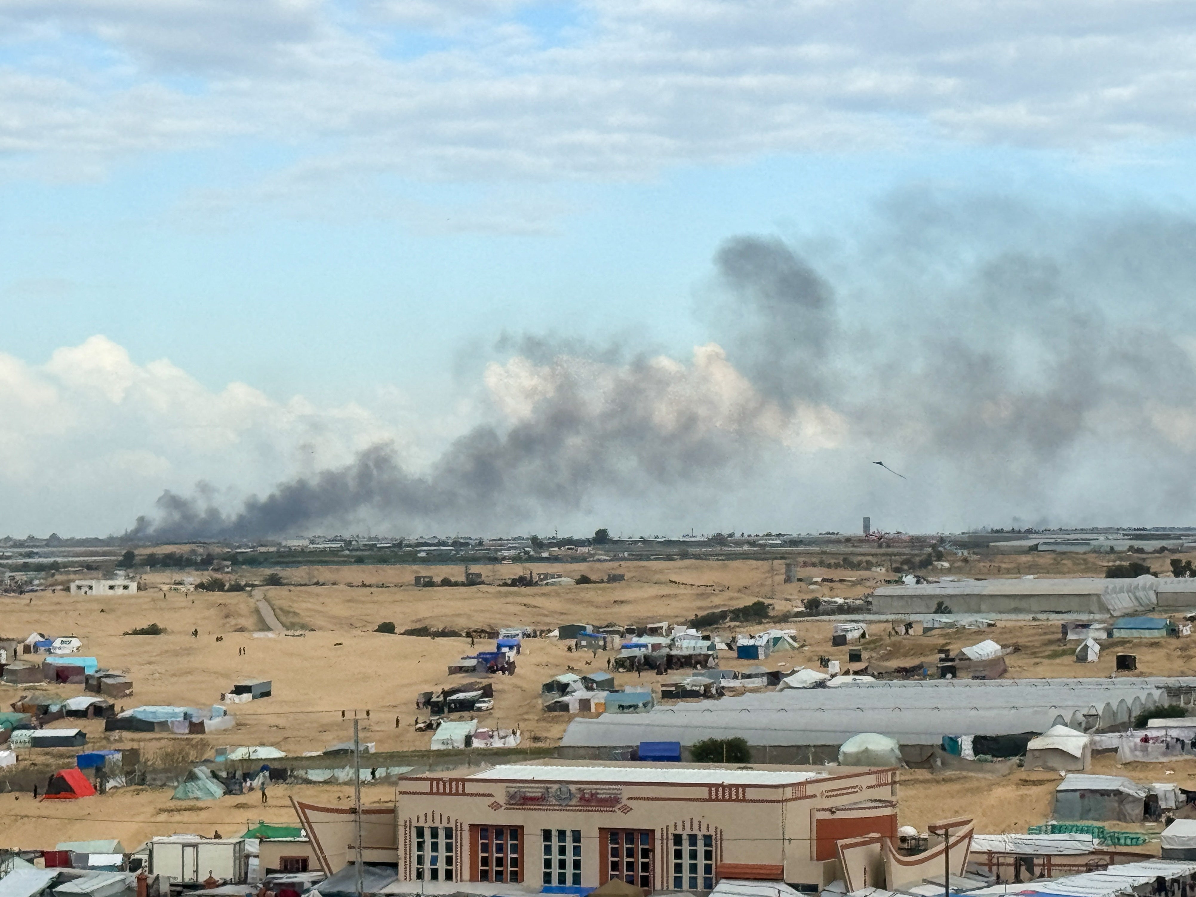 Smoke from the ground operation in Khan Younis, seen from a camp sheltering displaced Palestinians in Rafah