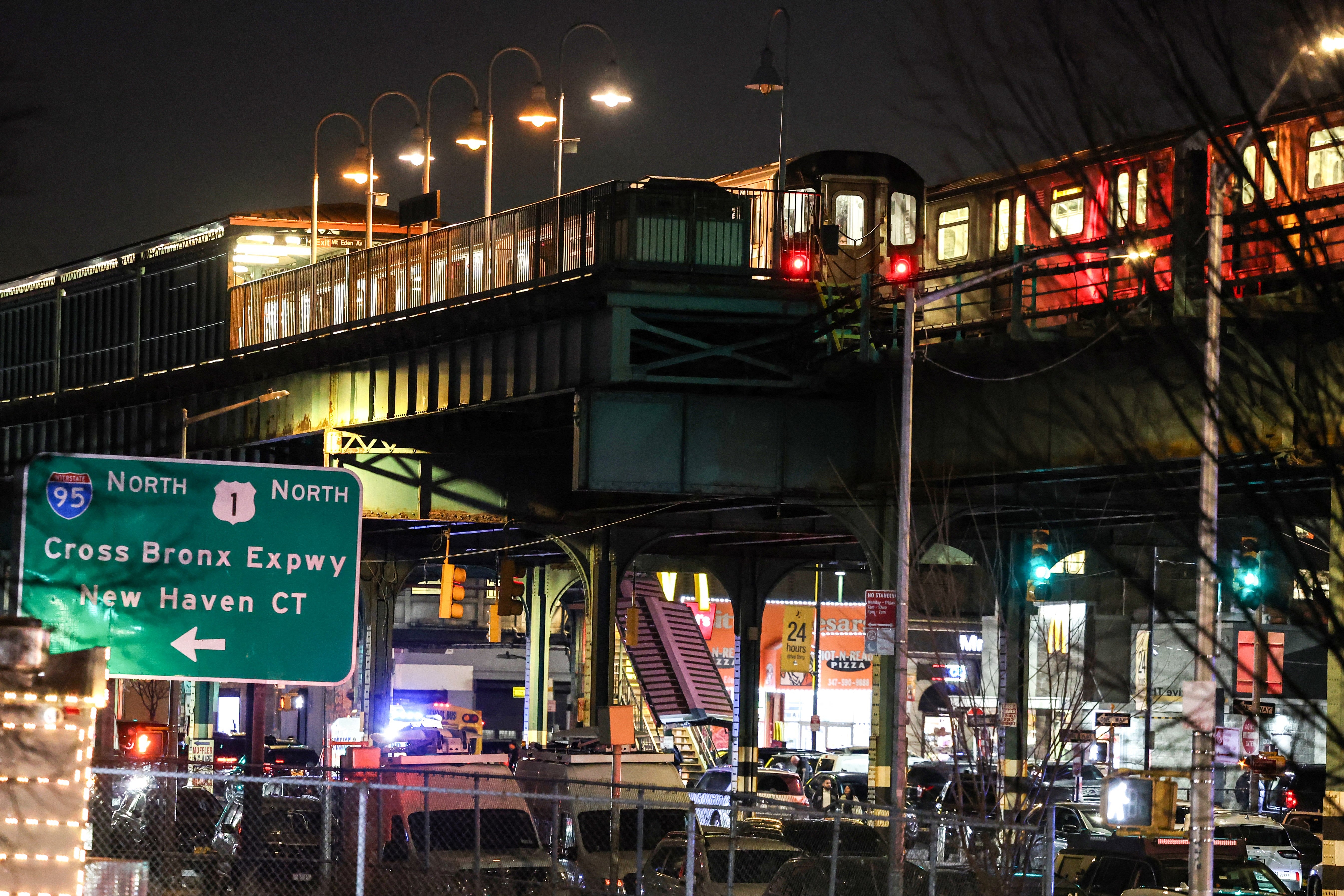 A train stands at the Mt Eden Avenue subway station in the Bronx borough of New York after six people were injured with one person in critical condition following a shooting at the subway station