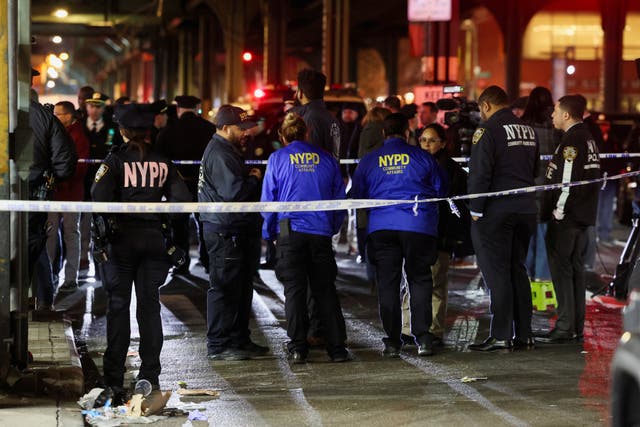 <p>Members of the New York Police Department (NYPD) investigate the scene of a shooting at the Mount Eden Avenue subway station in the Bronx borough of New York City</p>