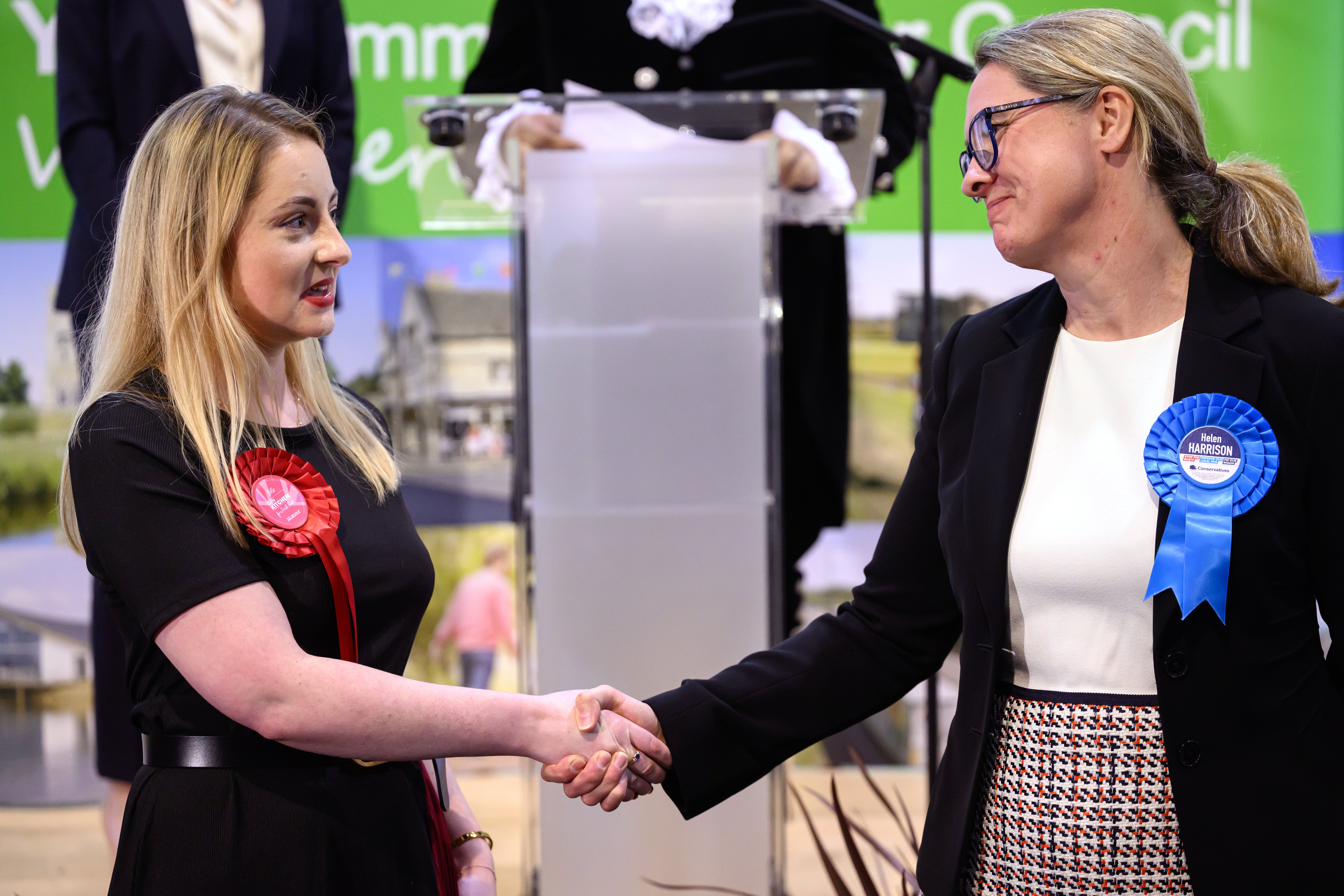 Labour Party candidate Gen Kitchen shakes hands with Conservative Party candidate Helen Harrison after being declared the winner