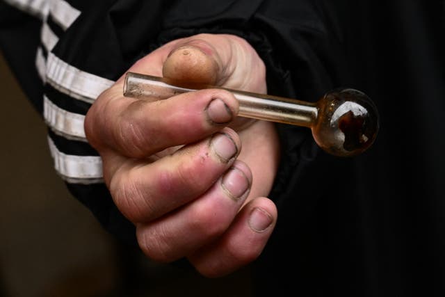 <p>A person holds a glass pipe used to smoke meth following the decriminalization of all drugs in downtown Portland, Oregon on January 25, 2024</p>