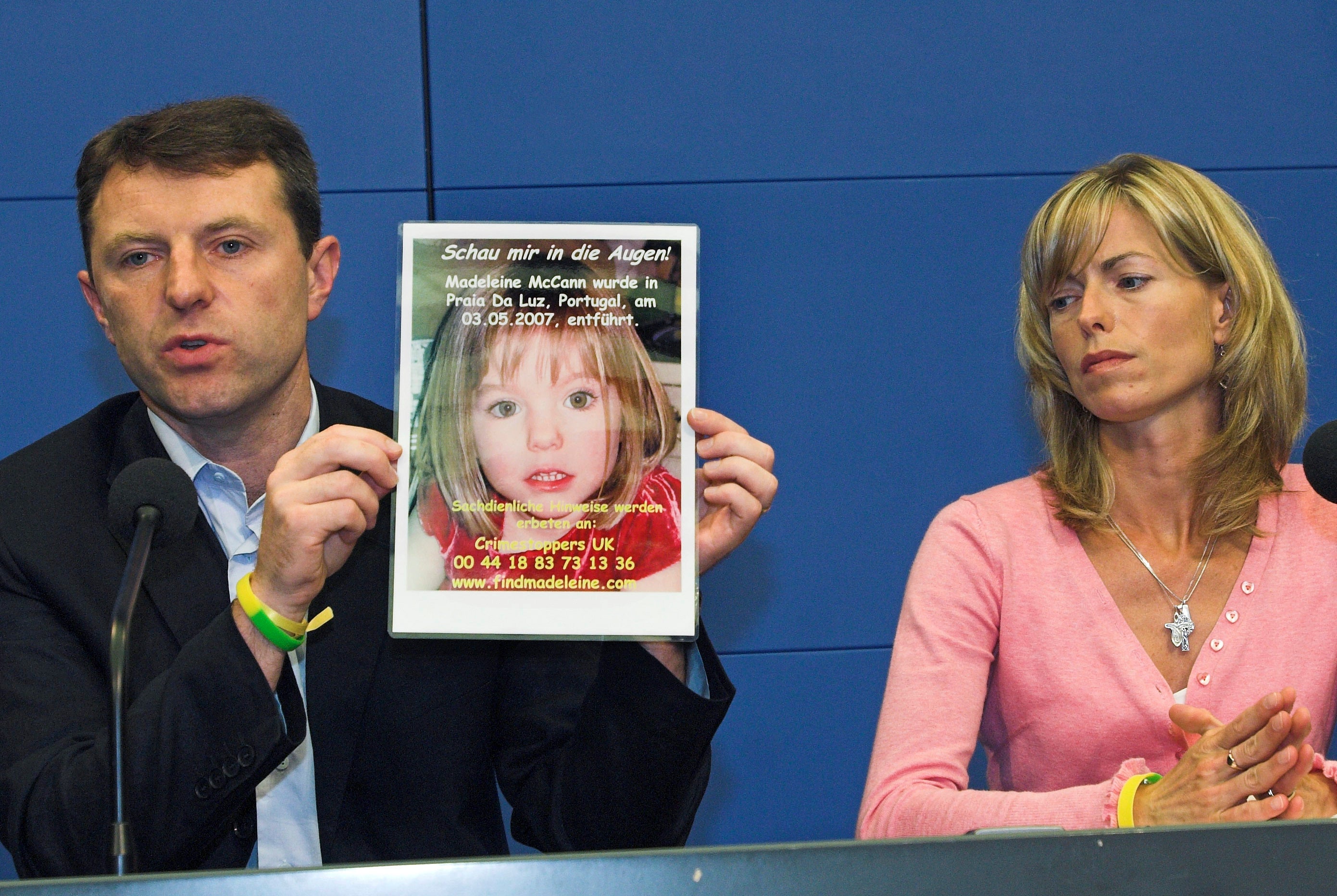 Gerry, left, and Kate McCann, hold up a poster of their four-year old Madeleine