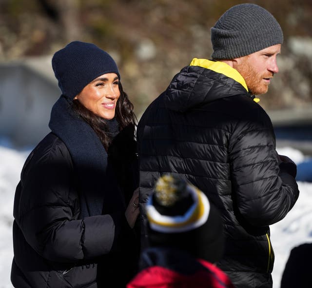 <p>Prince Harry and Meghan Markle, the Duke and Duchess of Sussex, walk together after Harry slid down the track on a skeleton sled while attending an Invictus Games training camp, in Whistler, British Columbia</p>