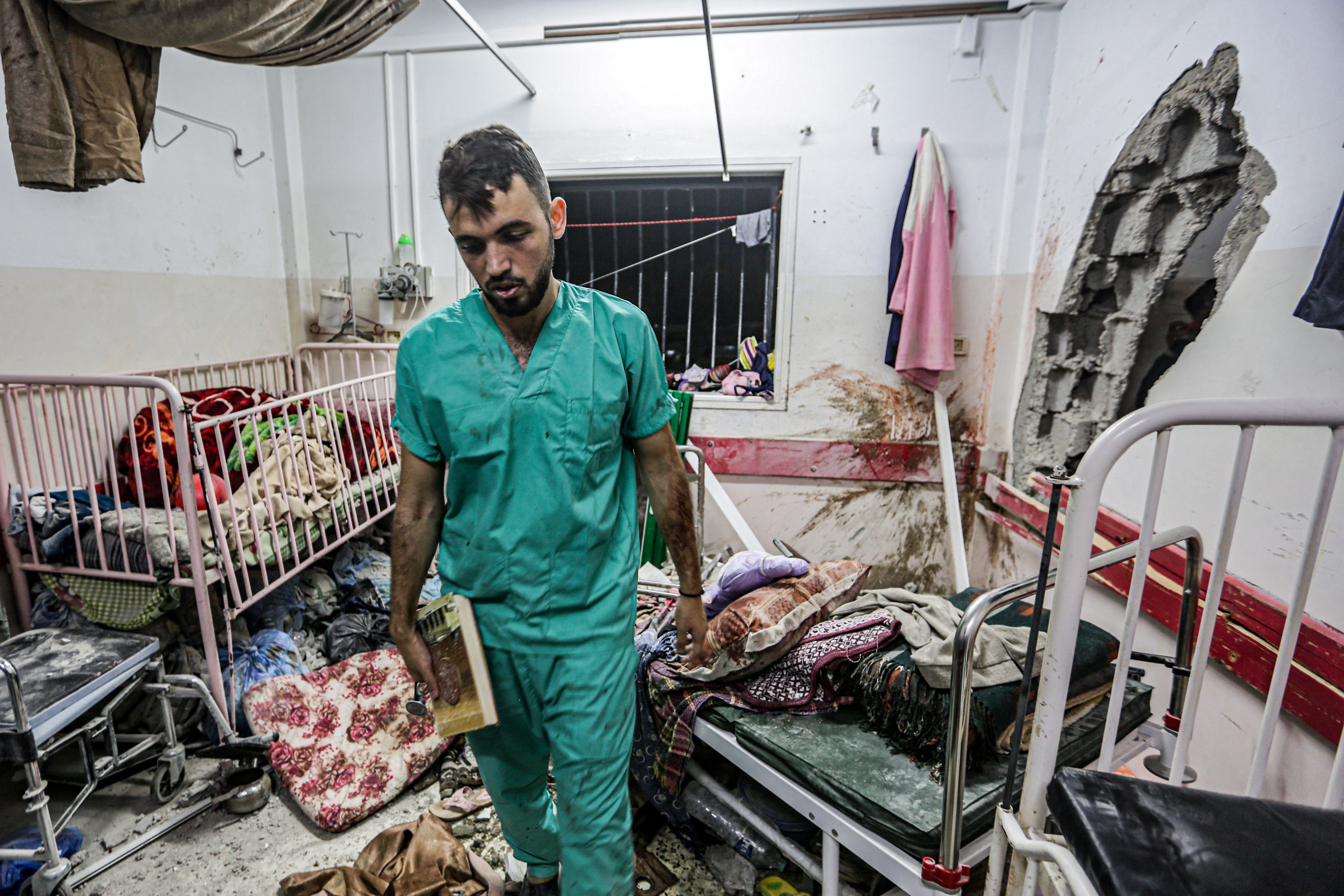 A man inspects the damage in a room following Israeli bombardment at Nasser hospital in Khan Yunis