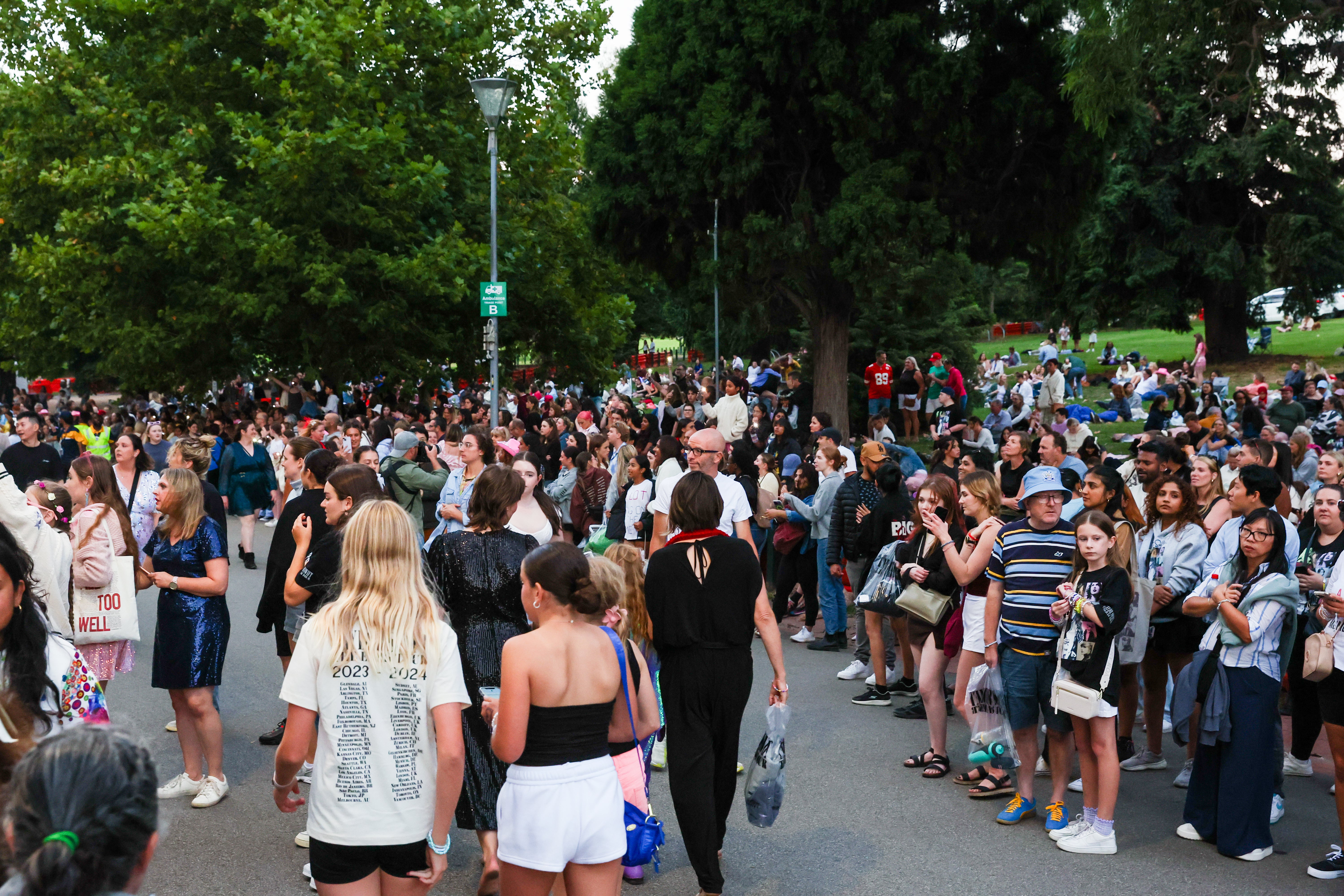 Taylor Swift fans with no tickets sing and dance during the concert outside the Melbourne Cricket Ground