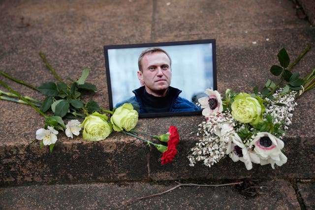 <p>A portrait of jailed Russian opposition leader Alexei Navalny and flowers are placed as people demonstrate near to Russian embassy to France</p>