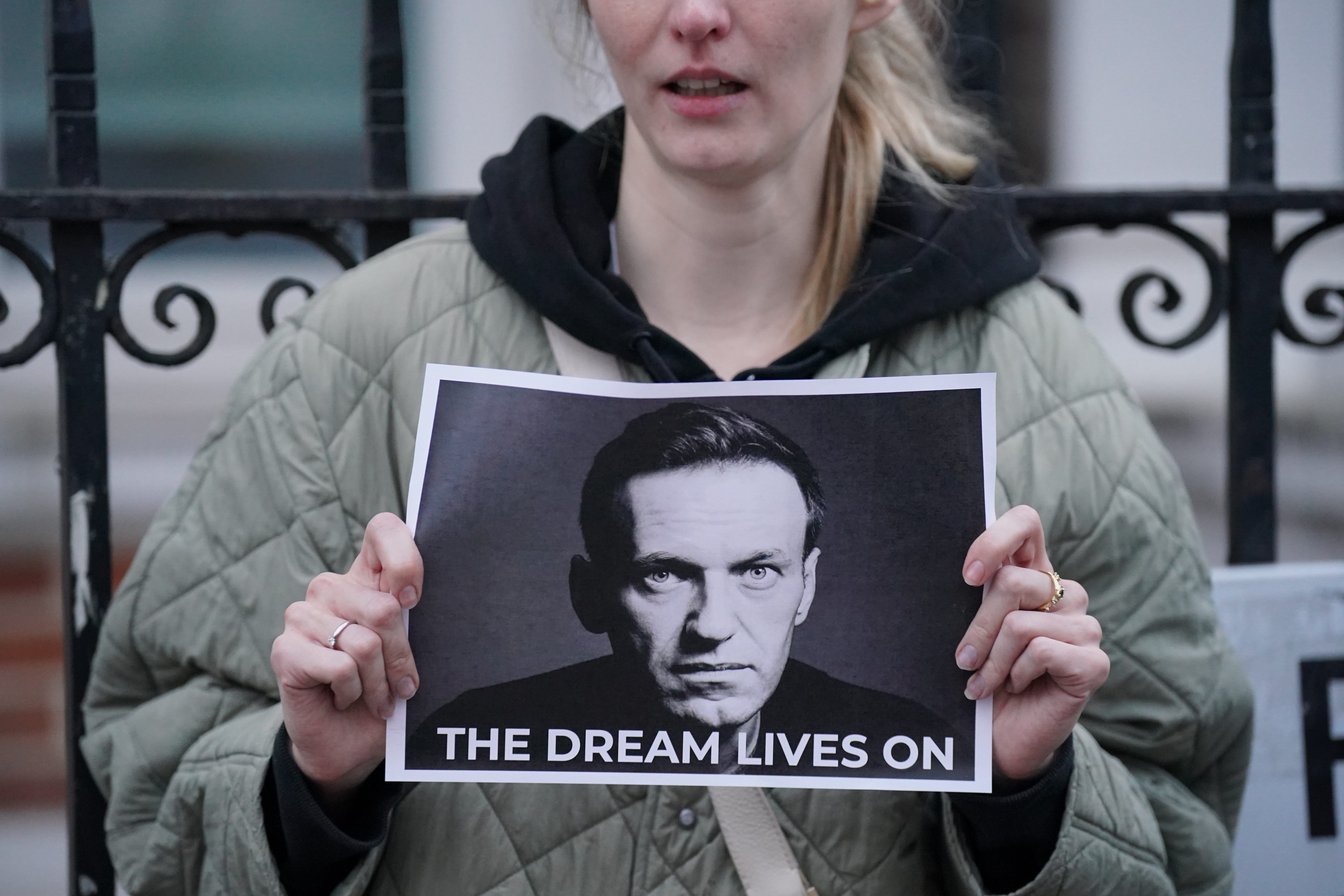 A protester holds a picture of Alexei Navalny at a protest opposite the Russian Embassy in London (Jonathan Brady/PA)