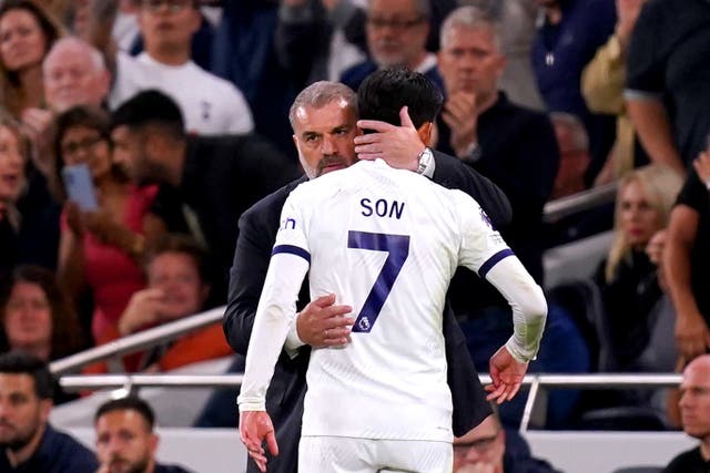 Son Heung-min is hugged by Tottenham manager Ange Postecoglou (John Walton/PA)