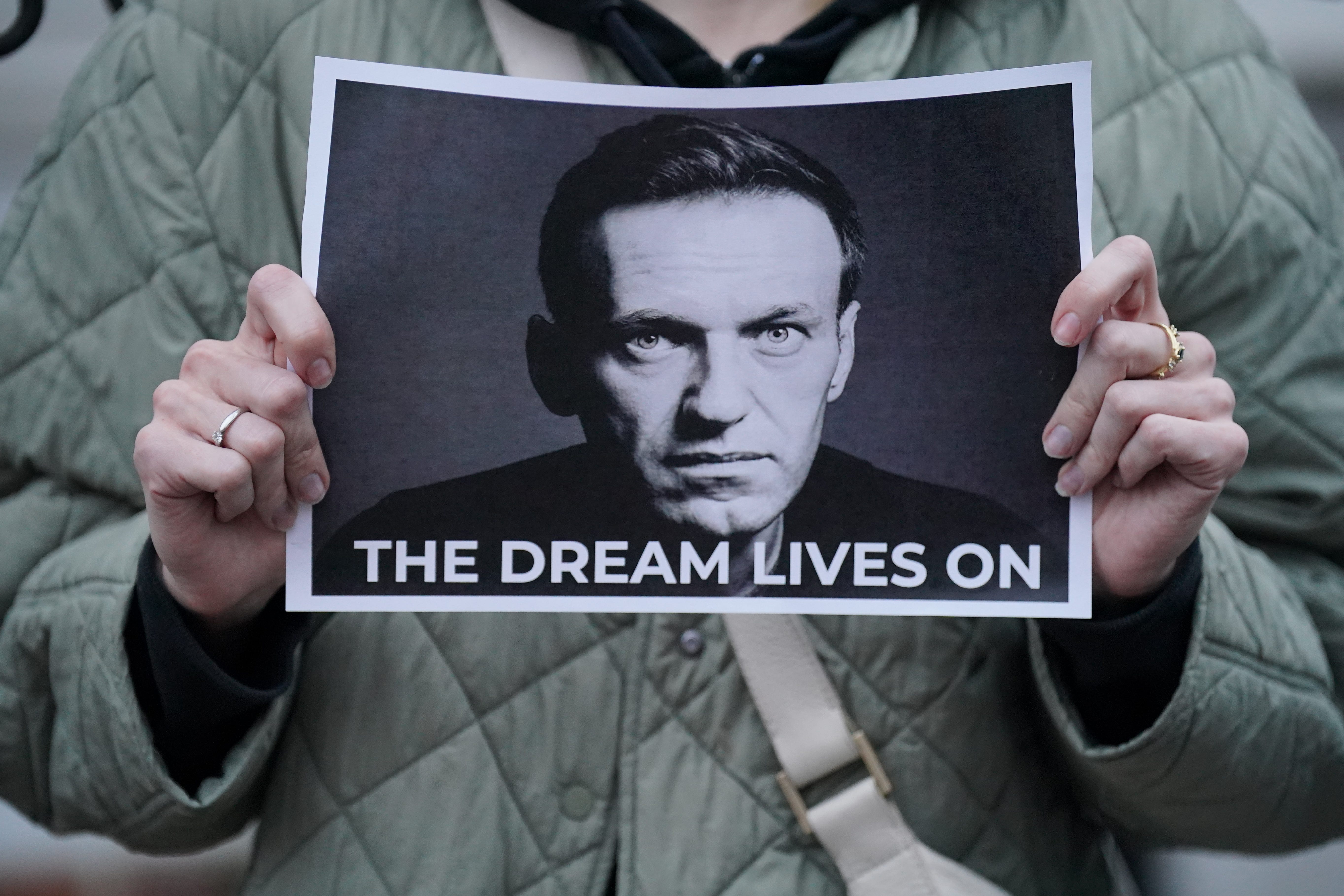 A protester holds a picture of Navalny at a protest opposite the Russian embassy in London