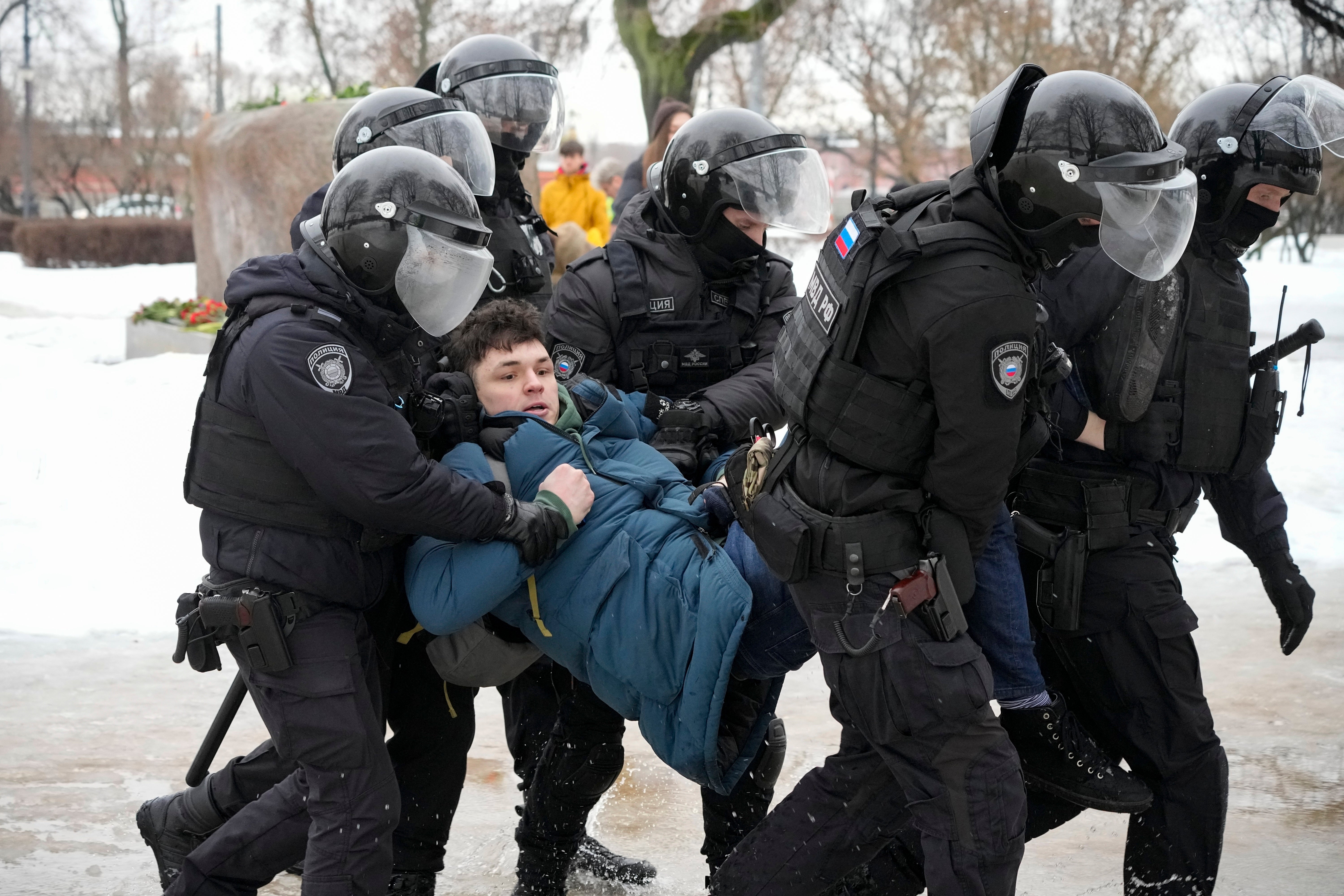 Police detain a man paying his last respects to Navalny in St Petersburg